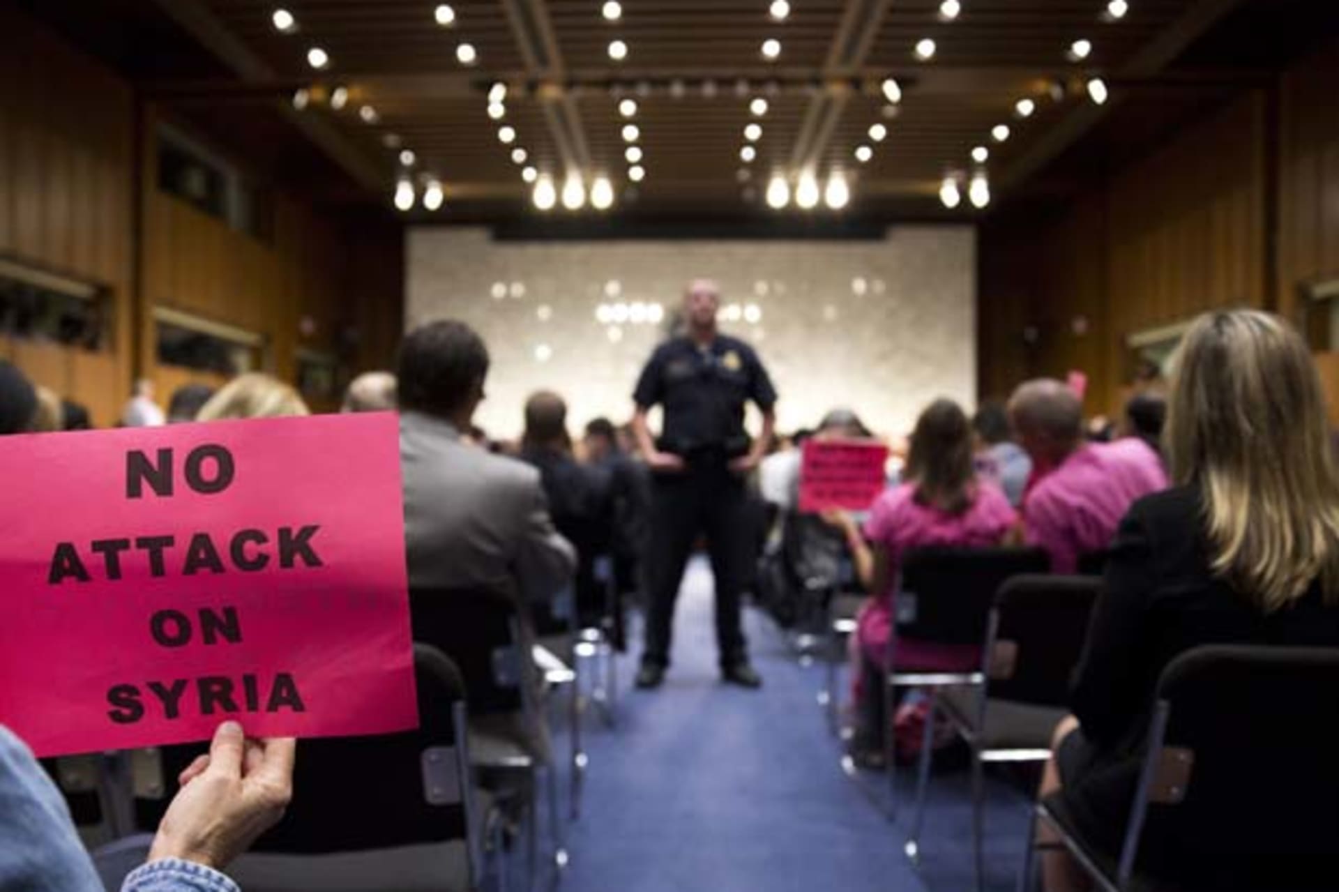 <p>A protester holds up a sign against U.S. action in Syria as Chairman of the Joint Chiefs General Martin E. Dempsey, Secretary … and Secretary of Defense Chuck Hagel testify before the Senate Foreign Relations Committee (Joshua Roberts/Courtesy Reuters).</p>
