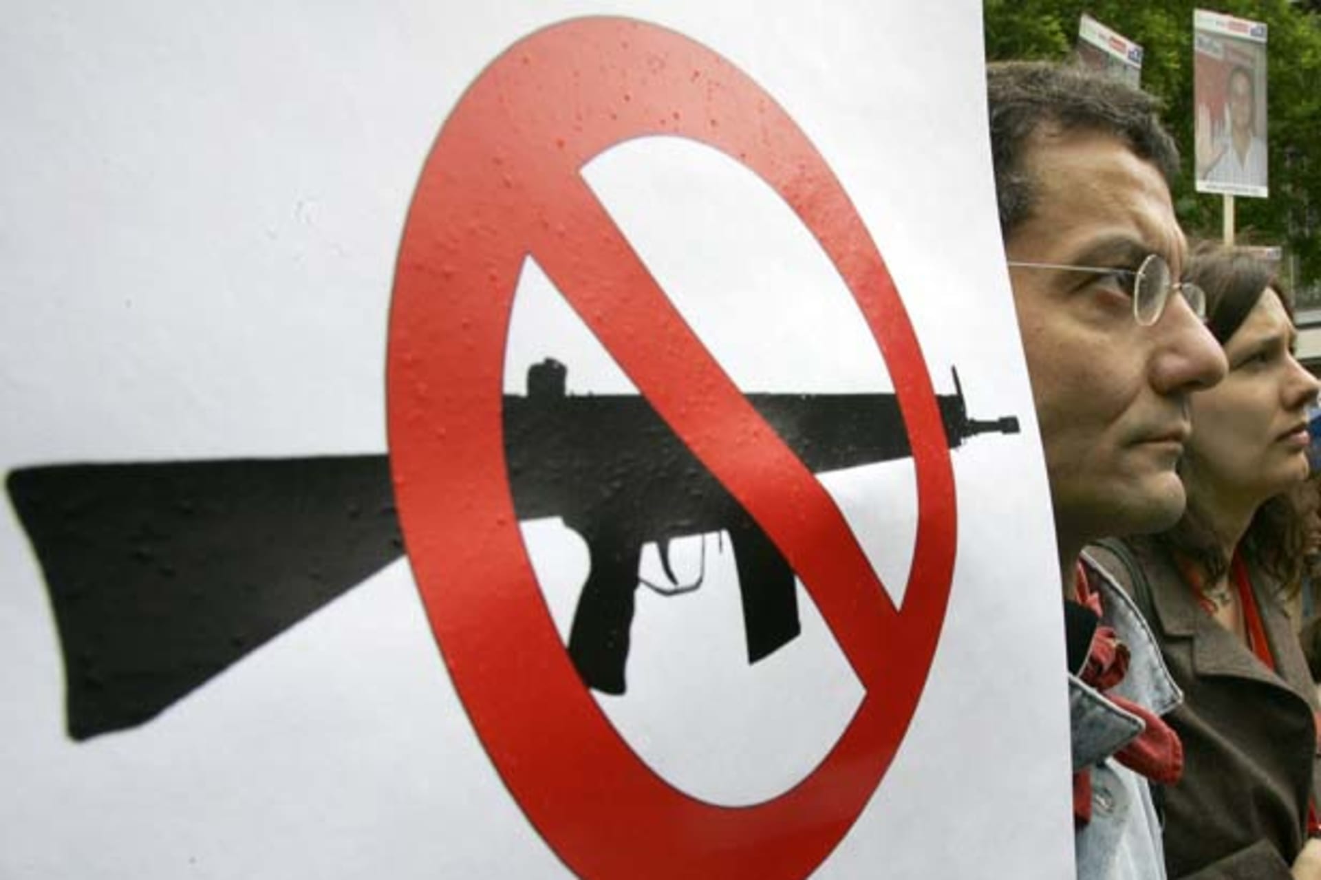 Activists of amnesty international are pictured beside a placard during a demonstration in Berlin to ban the international arms trade