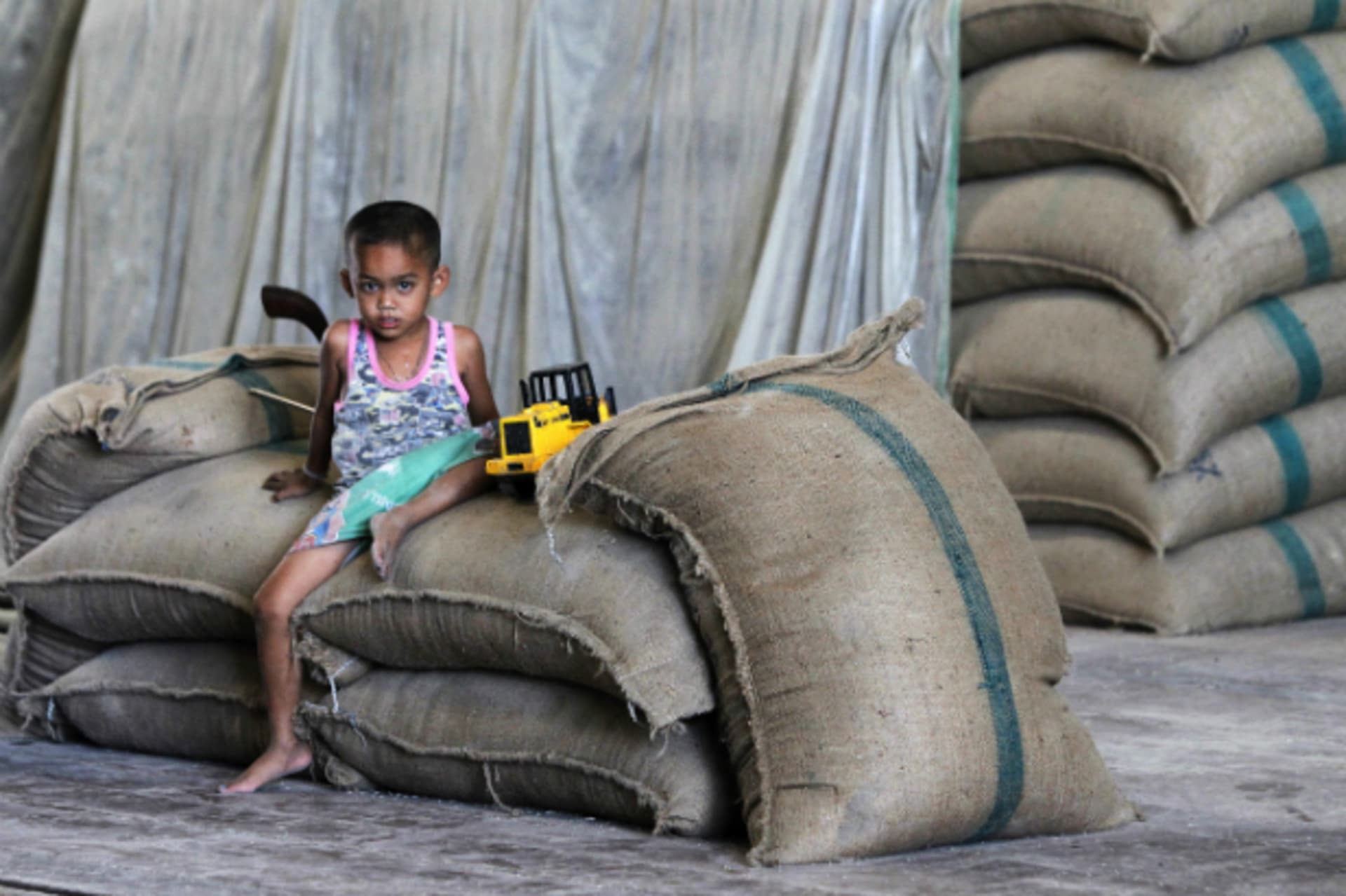 <p>A child sits on a bag of milled rice at a mill in Suphan Buri province, north of Bangkok on March 11, 2013. Thailand was set t…eteriorating in quality in warehouses filled with grain bought under a government scheme. (Chaiwat Subprasom/Courtesy Reuters)</p>

