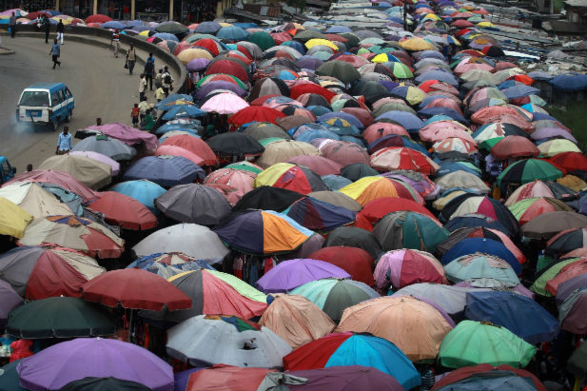 Street traders covers stalls with umbrellas along abandoned railway line in Nigeria's oil hub city of Port Harcourt December 3, 2012.