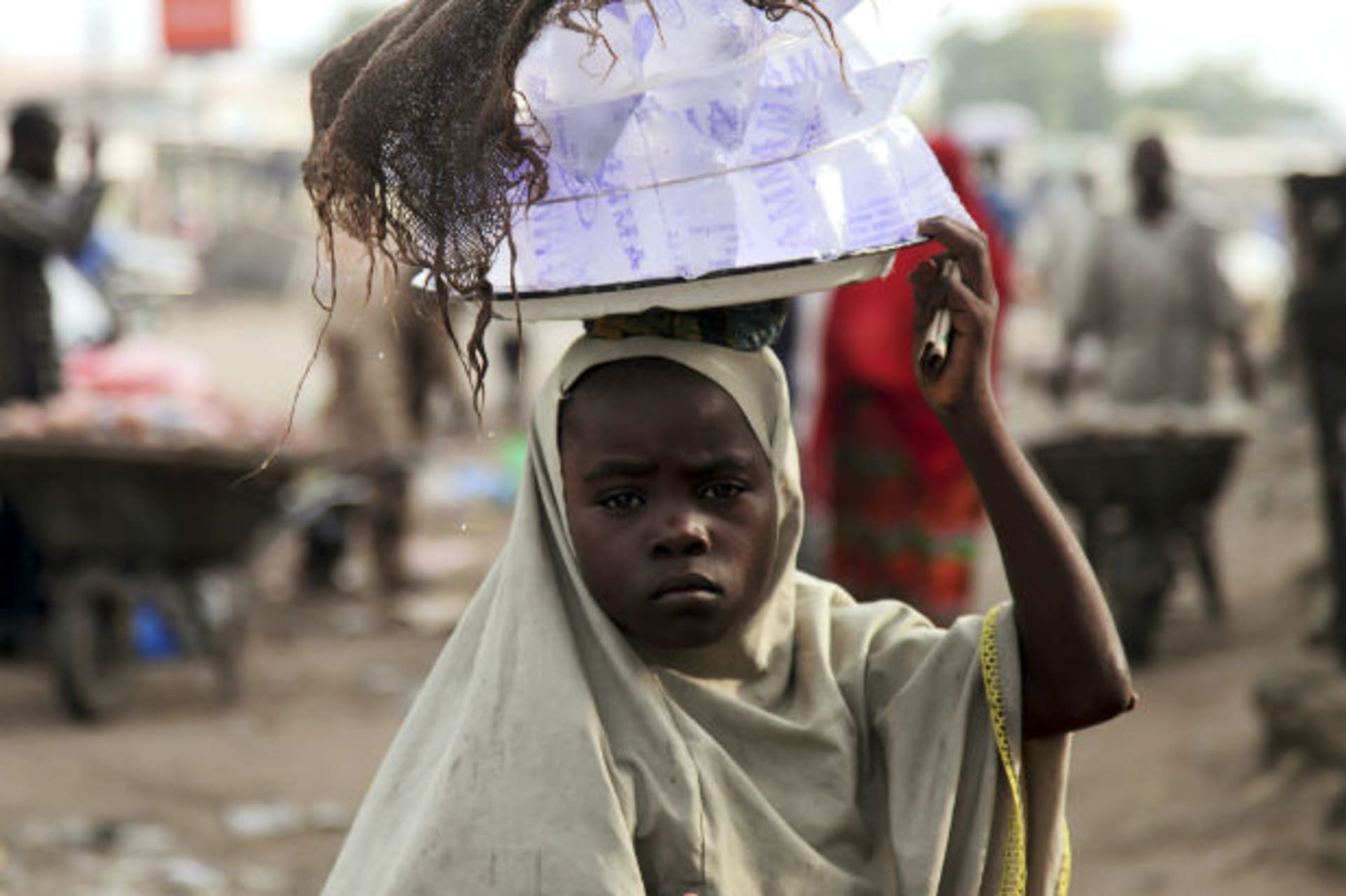 DATE IMPORTED:August 4, 2009A girl hawks drinking water packed in sachets along a street after days of religious clashes in the northern Nigerian city of Maiduguri, August 4, 2009.