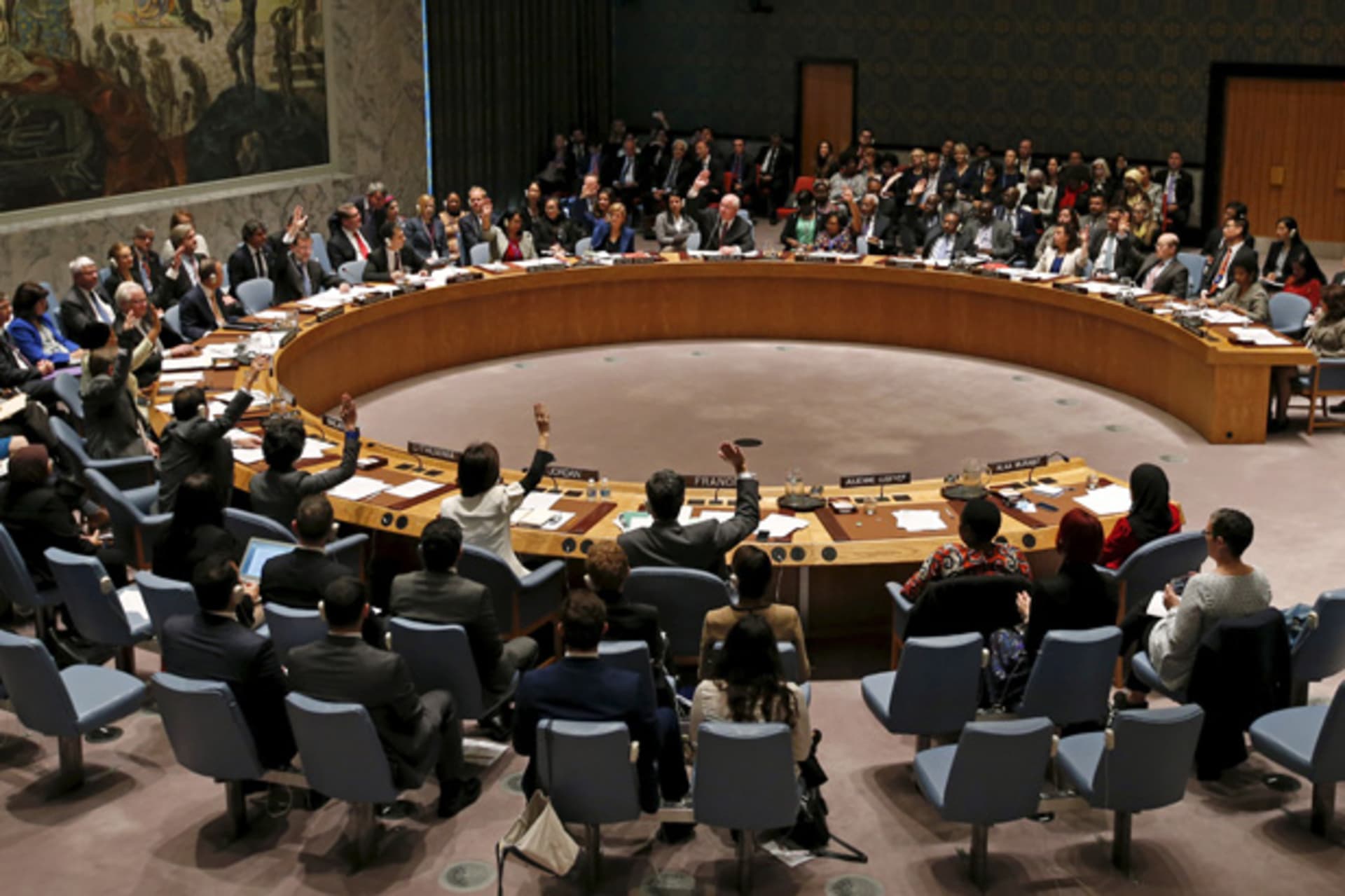 The United Nations Security Council votes in favor of a resolution during a meeting of the Council on Women, Peace and Security at U.N. headquarters in New York