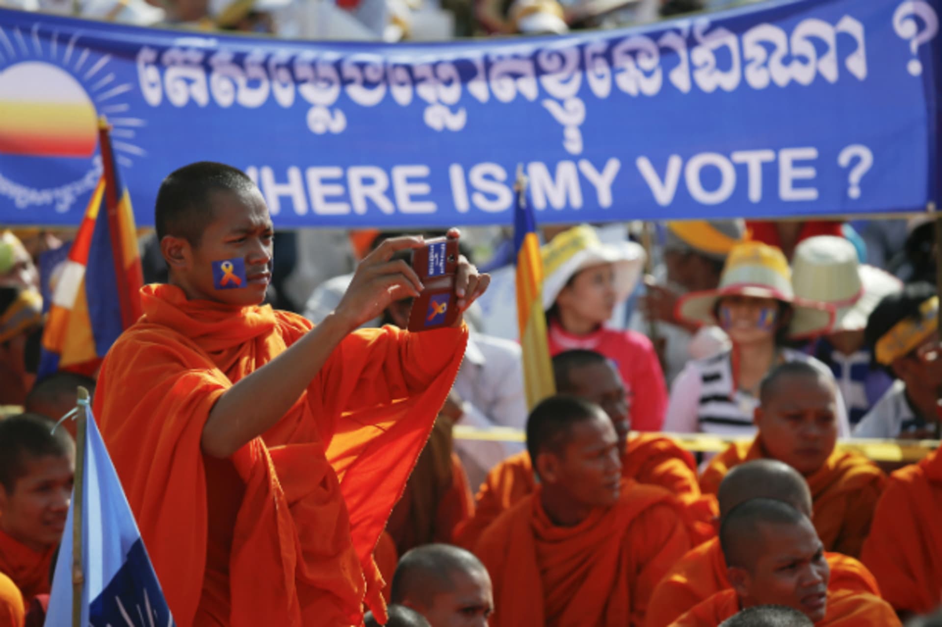 <p>A Buddhist monk records the speech of one of the leaders of Cambodia National Rescue Party (CNRP) during a rally in Phnom Penh on September 7, 2013. (Damir Sagolj/Courtesy Reuters)</p>
