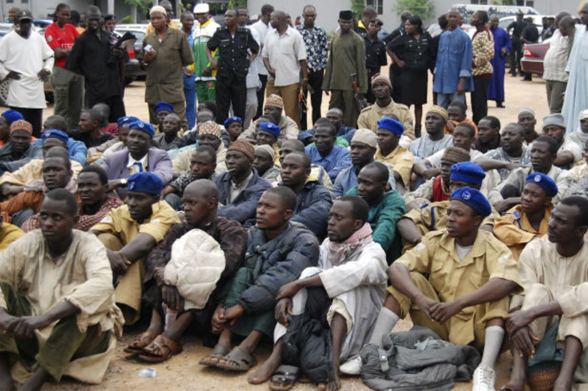 Members of a local Islamic group sit after their arrest in Kano, Nigeria 28/07/2009.