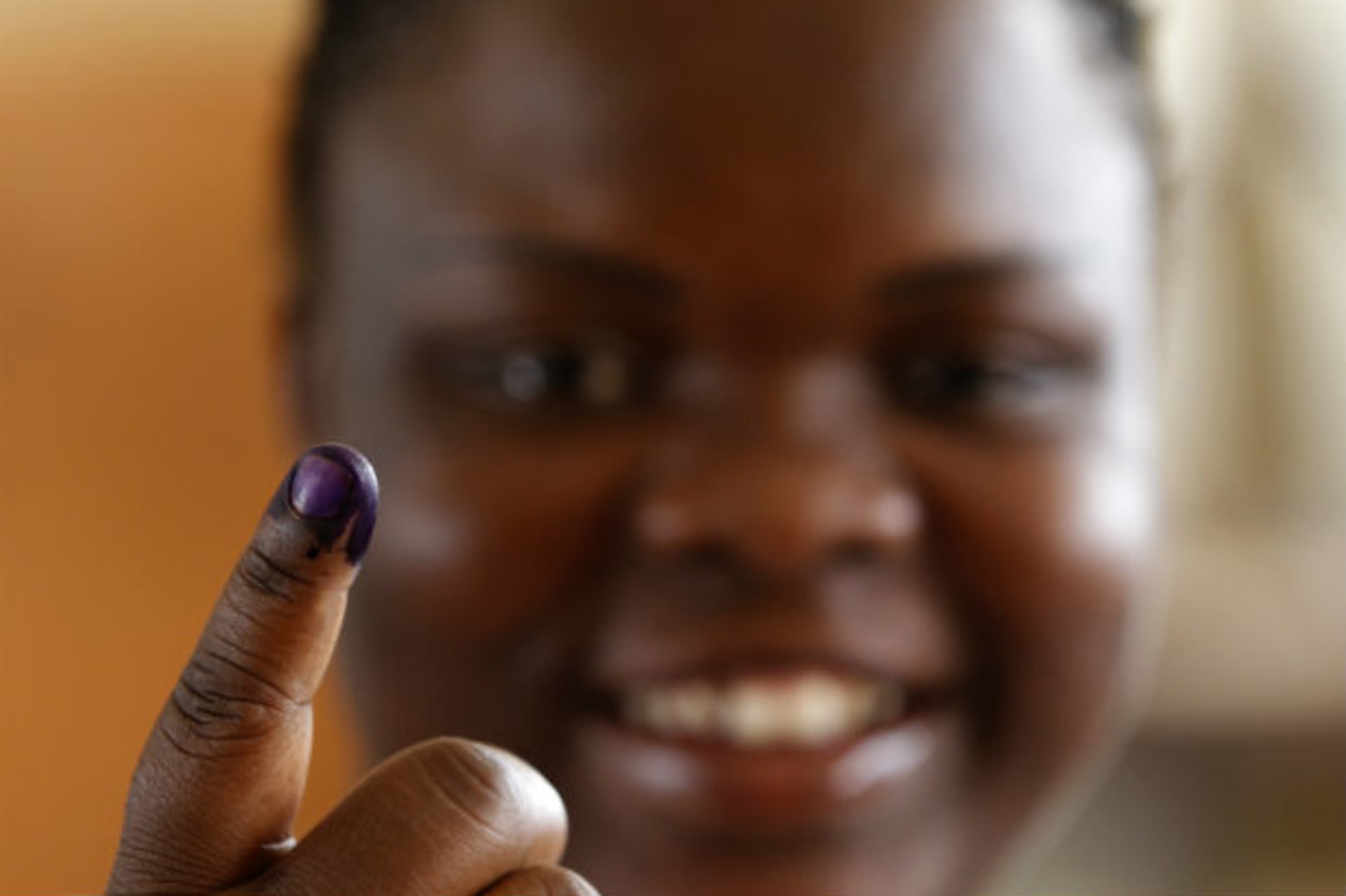 Woman with shows off her inked finger after casting her vote during the national elections in the capital Luanda, Angola 31/08/2012.
