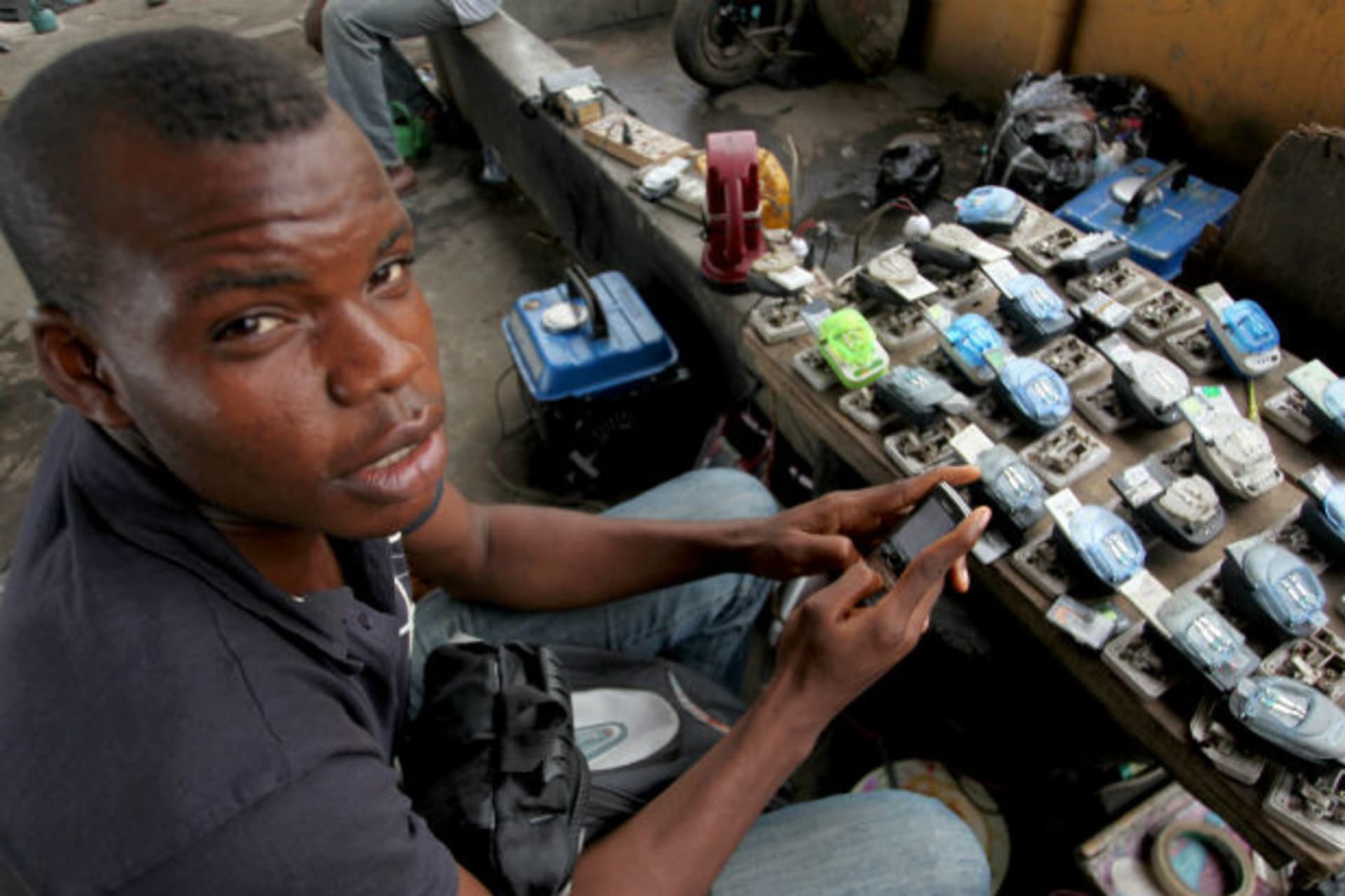 Jamil Idriss charges 50 naira ($0.33) to recharge phone batteries using rows of three-pin sockets nailed to a plank of wood and plugged into a diesel generator in the Obalende District of Lagos May 20, 2010.
