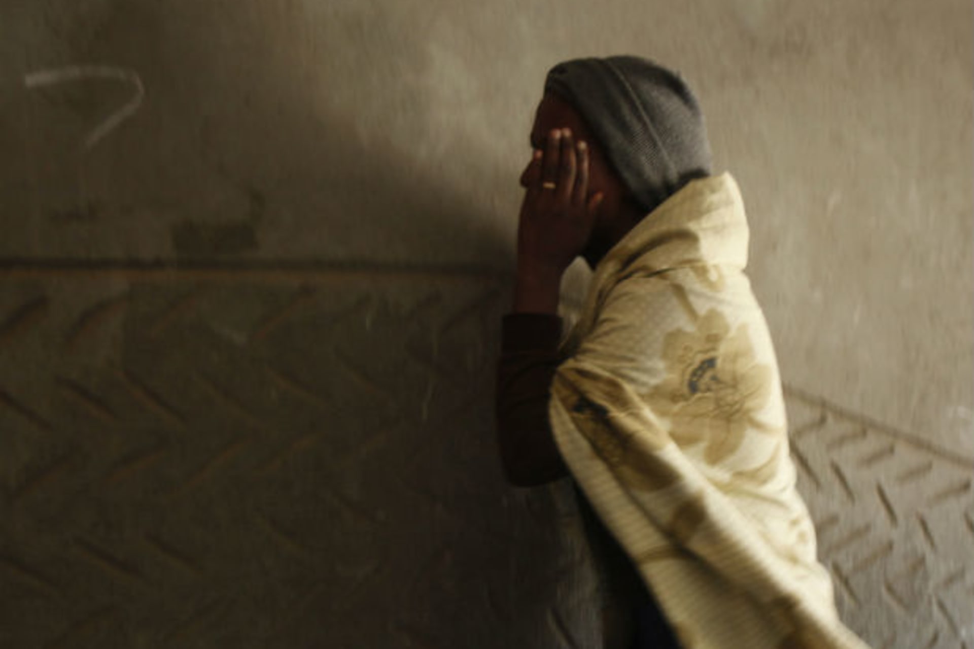A migrant from Eritrea walks in a building, used to house people waiting to be smuggled into Israel, near the Egyptian-Israeli border in Sinai December 25, 2010.