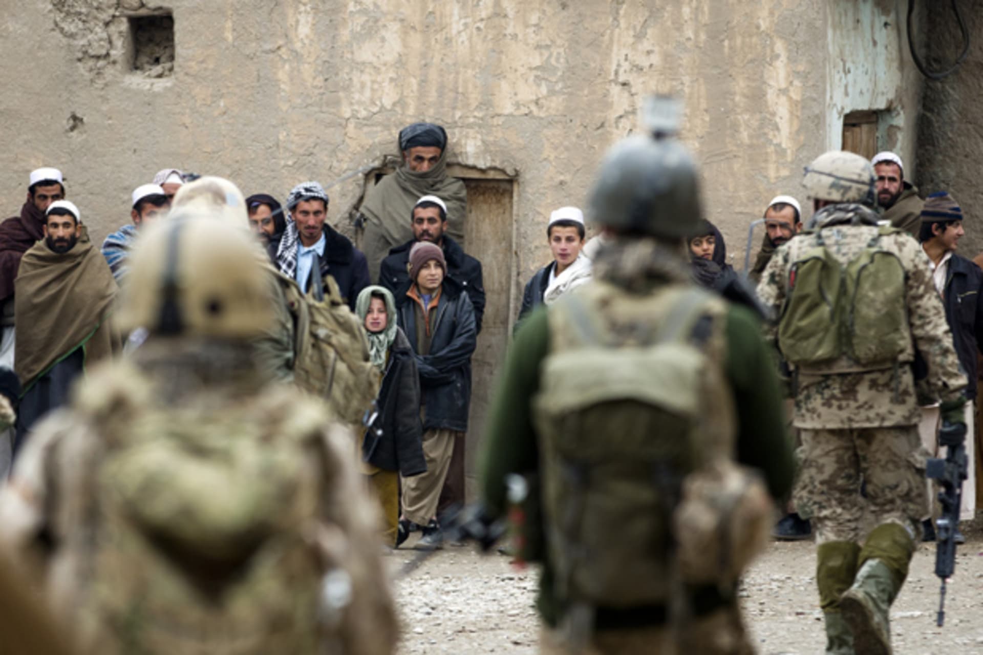 German ISAF soldiers approach locals during patrol in village of Isa Khel