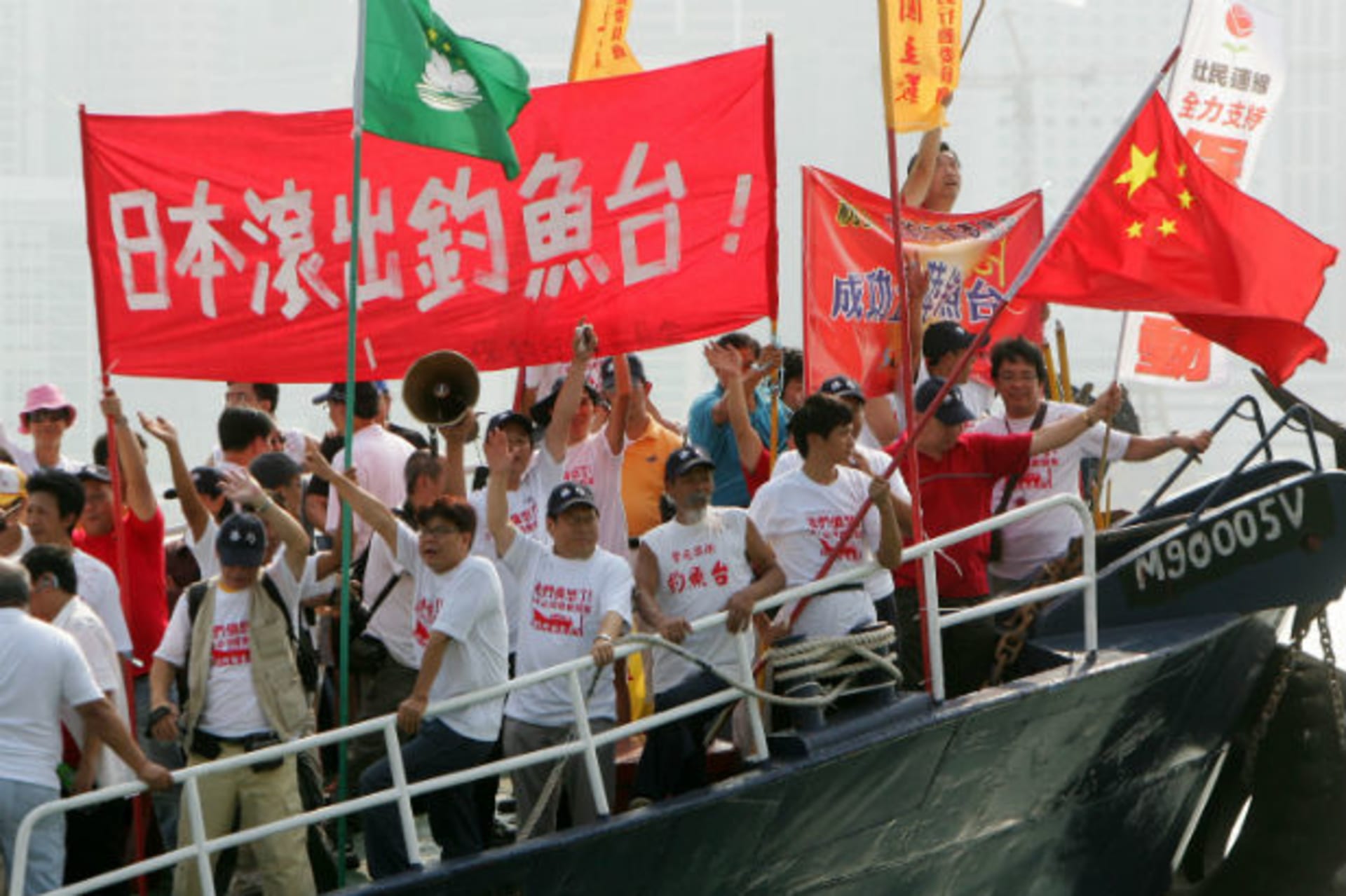 <p>Activists from the Hong Kong-based Action Committee for Defending the Diaoyu Islands shout slogans and wave the Chinese flag o…g October 22, 2006. The banner written in Chinese reads “Japan get out of the Diaoyu Islands”. (Paul Yeung / Courtesy Reuters)</p>
