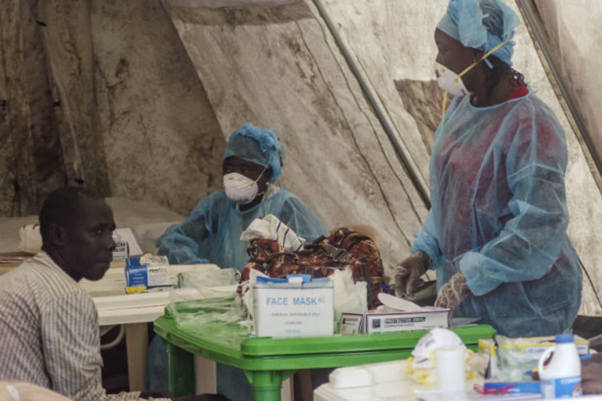 <p>Health workers screen patients for the Ebola virus at a local government hospital in Kenema, Sierra Leone, on June 30, 2014.</p>
