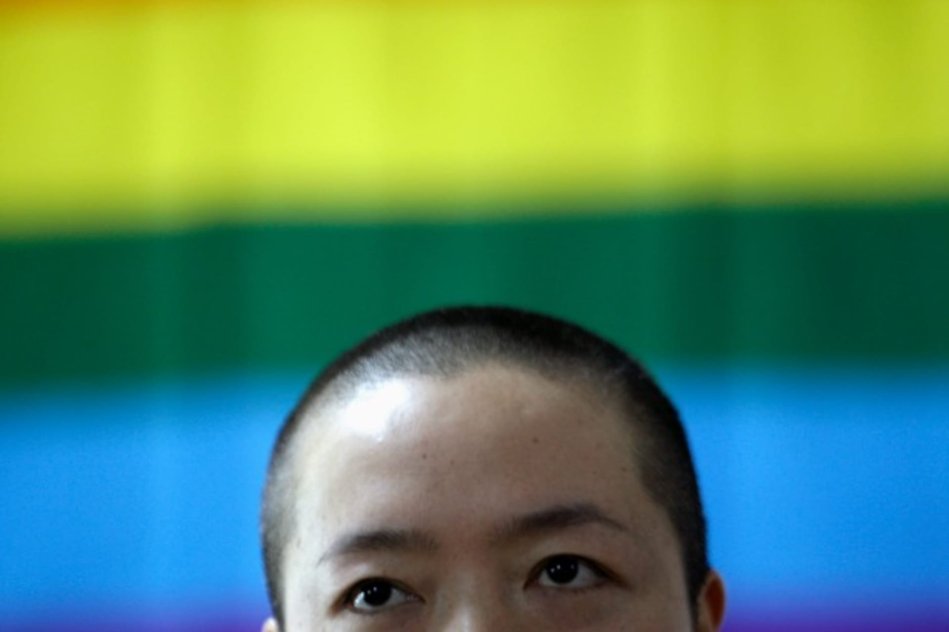 <p>Shi tou (not her real name), a lesbian, is seen in front of a rainbow flag during a campaign to promote the acceptance of homo… also an ideal time to campaign for same-sex marriages and the acceptance of homosexuality in China. REUTERS/Jason Lee (CHINA)</p>

