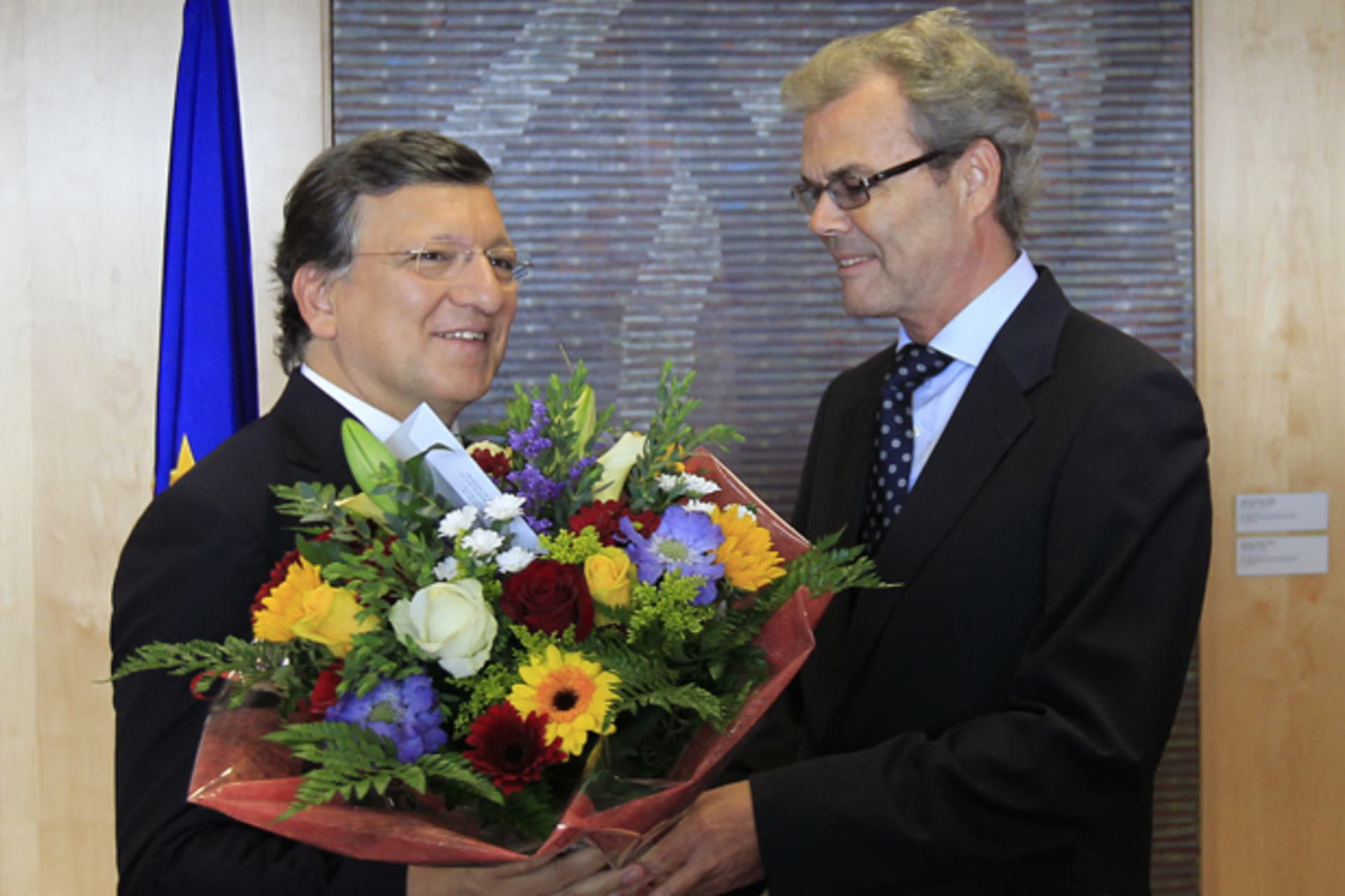 European Commission President Barroso receives flowers from Leikvoll, Norway's Ambassador to the European Union, at the EC headquarters in Brussels