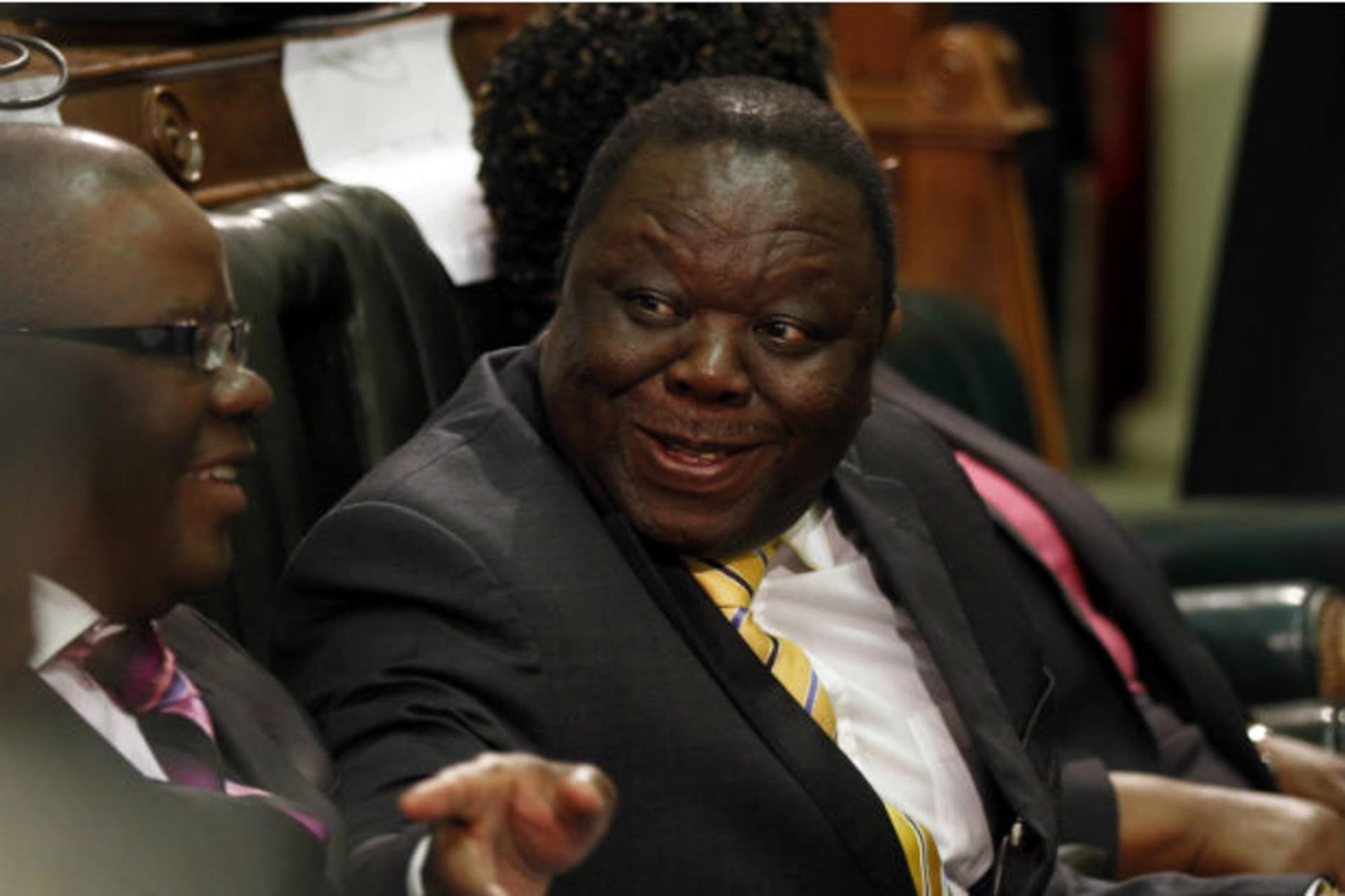 Zimbabwe's Prime Minister Morgan Tsvangirai (R) speaks to Finance Minister Tendai Biti before President Robert Mugabe opened the country's Parliament in Harare, October 30, 2012.