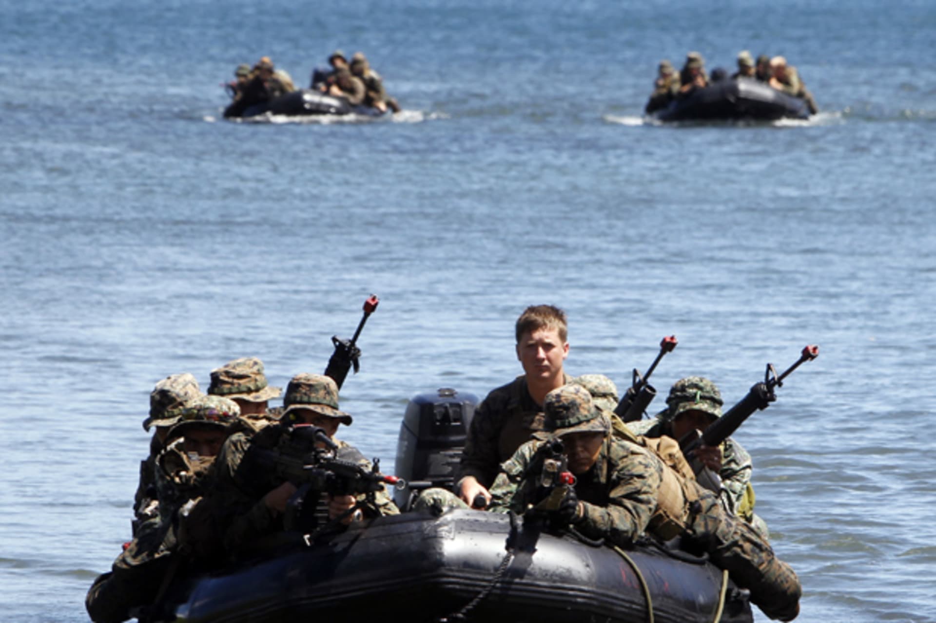 Philippine and U.S. marines sit in rubber dinghies during an amphibious raid as part of a Philippine-U.S. joint military exercise in Ulugan bay