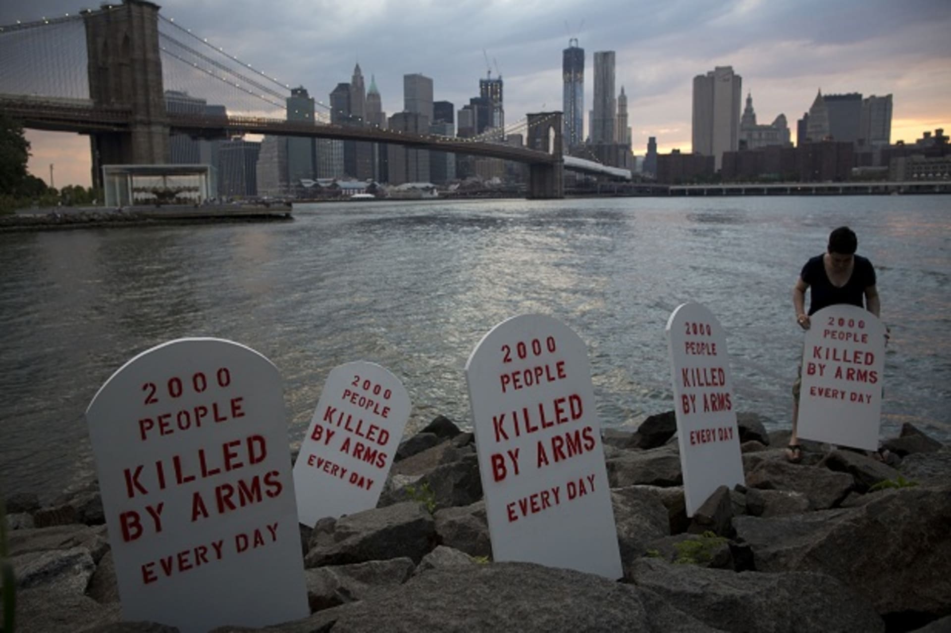 Fake tombstones are placed along the East River by members of the Control Arms Coalition to coincide with a diplomatic conference on the future Arms Trade Treaty in New York