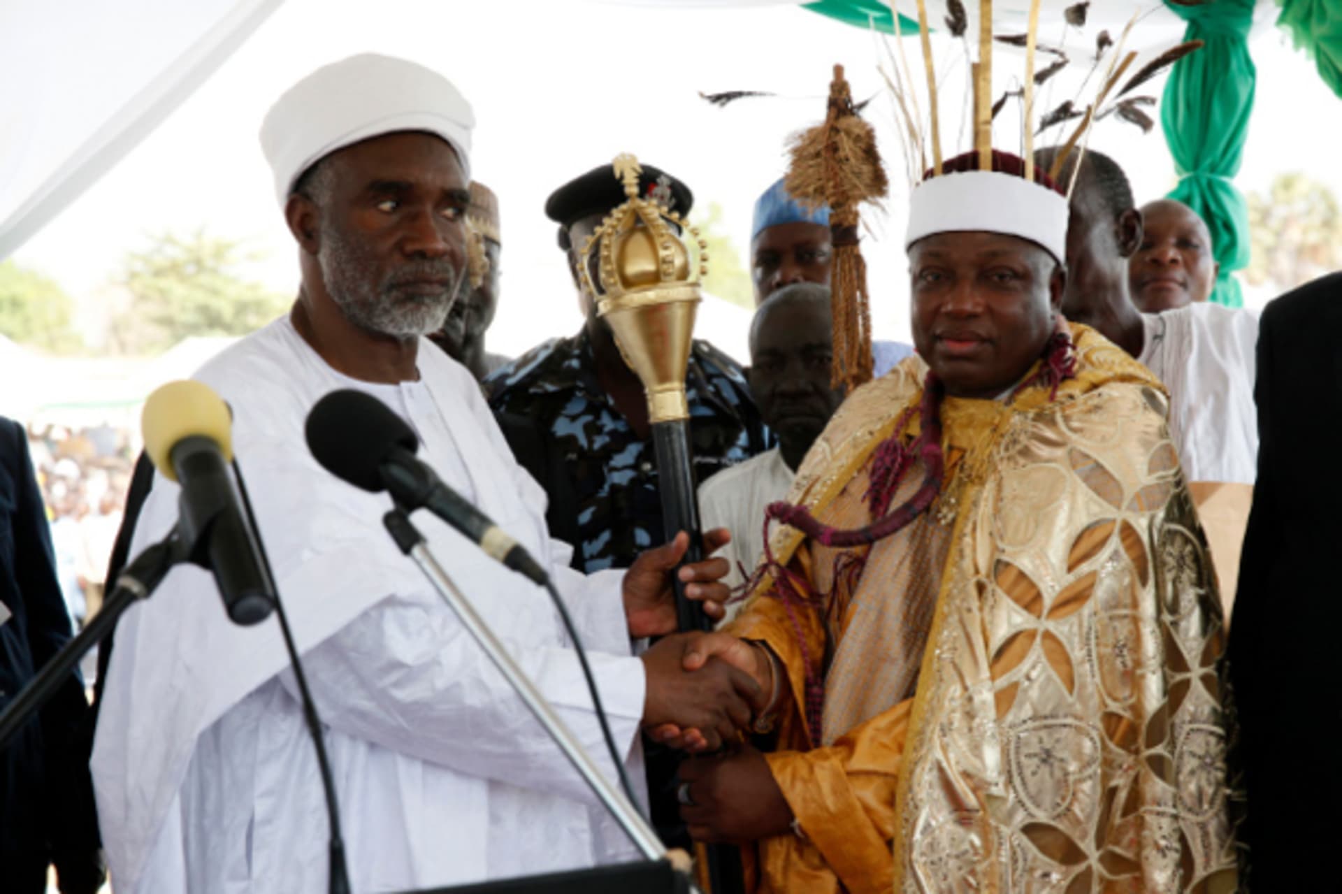 Kwire-Mana, Kpafrato II, Homun Honest Stephen (R), receives his staff of office from Adamawa State Governor, Murtala Nyako, during a presentation ceremony at Makwada Square in Numan, Adamawa state, December 7, 2013.