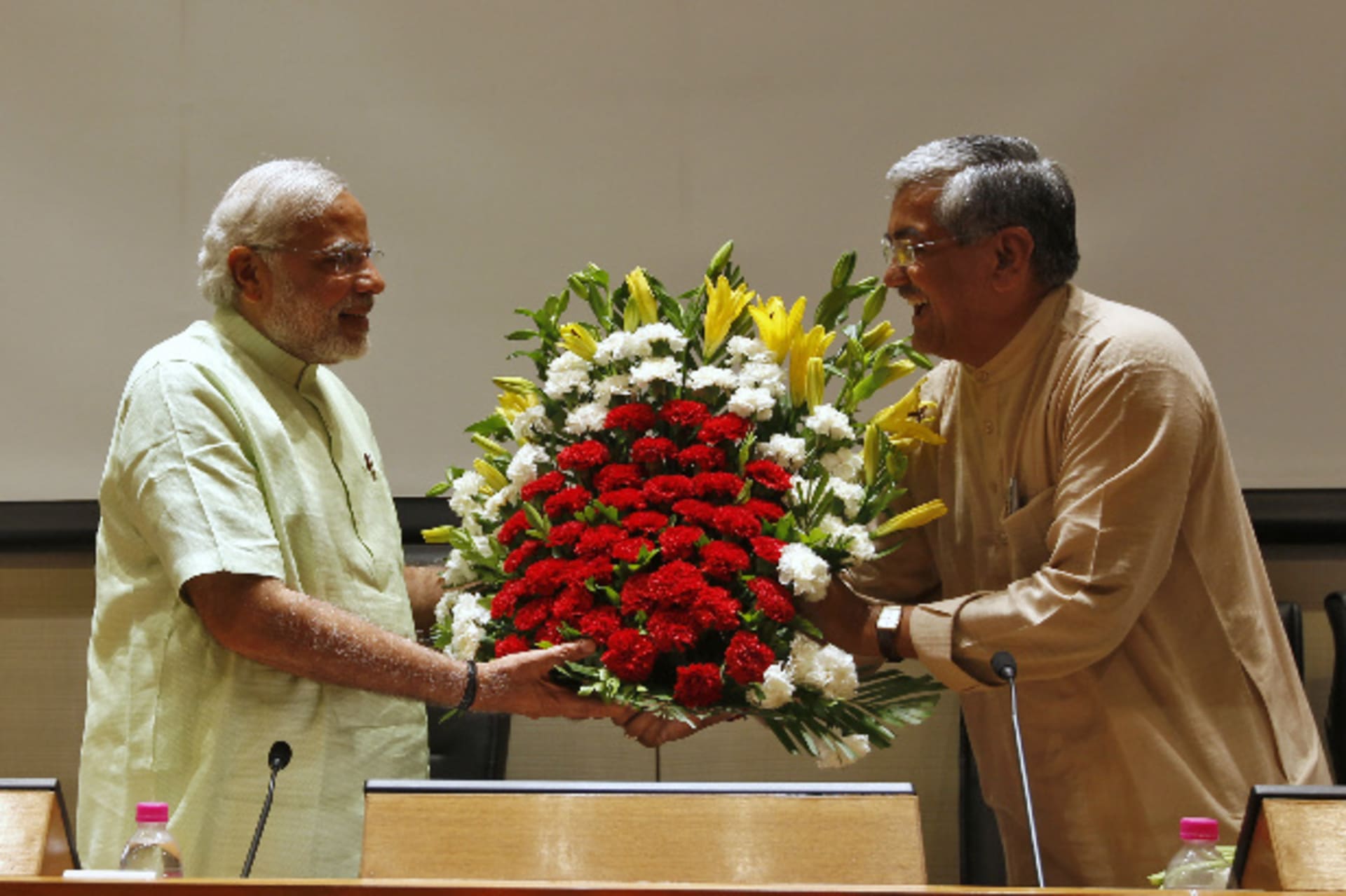 <p>Narendra Modi (L), the prime ministerial candidate for India’s main opposition Bharatiya Janata Party (BJP), receives a bouque…party leaders and workers at Gandhinagar in the western Indian state of Gujarat on May 13, 2014 (Amit Dave/Courtesy: Reuters).</p>
