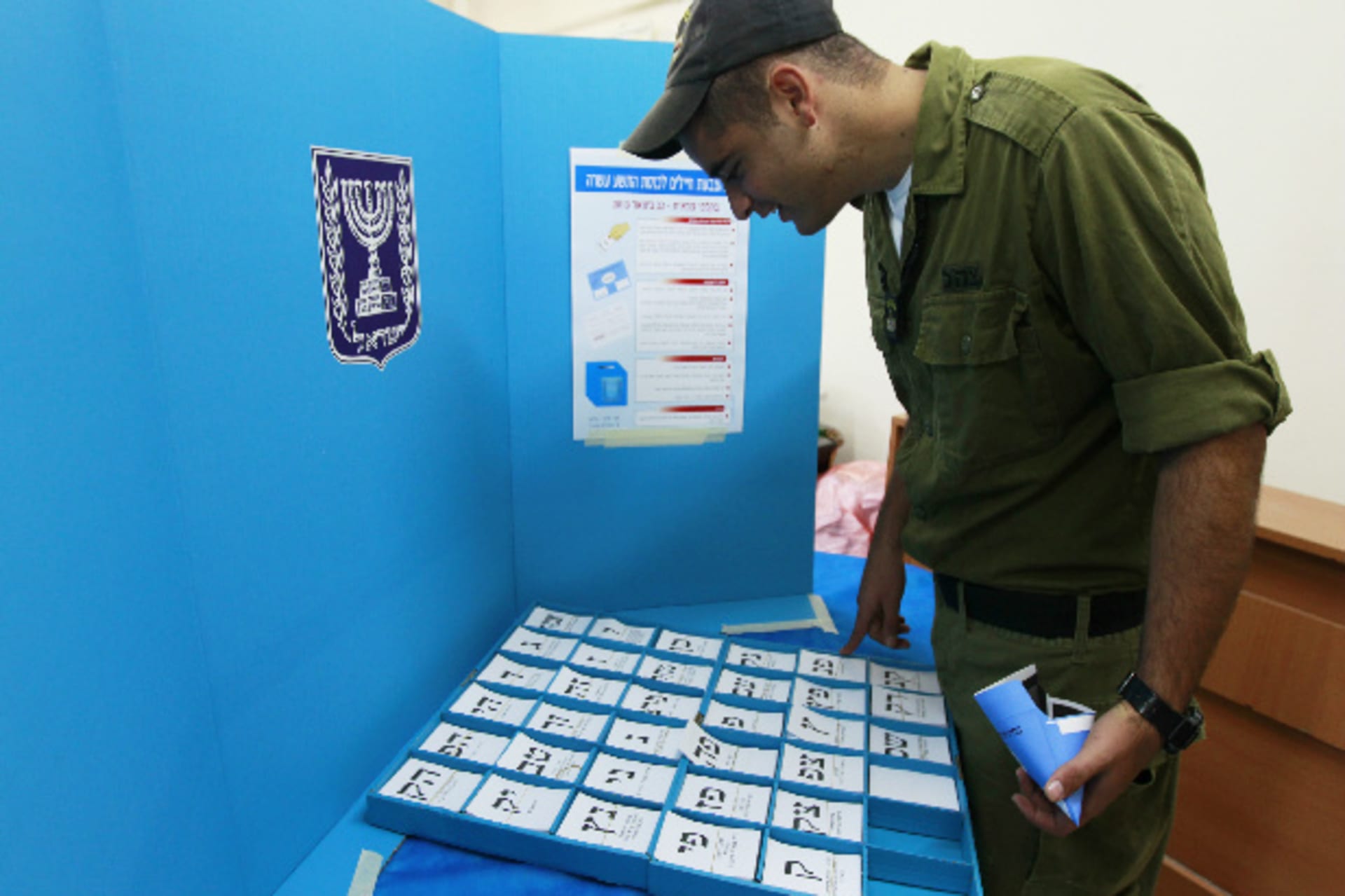 An Israeli soldier picks his ballot at a polling station in a navy base in the southern city of Ashdod January 20, 2013 (Cohen/Courtesy Reuters).