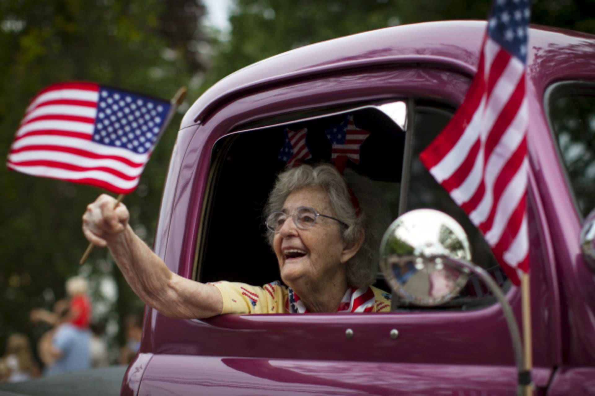 <p>A woman waves an American flag as she rides in an antique pickup truck through Barnstable Village on Cape Cod, during the annual Fourth of July Parade celebrating the country’s Independence Day, in Barnstable, Massachusetts (Mike Segar/Reuters).</p>
