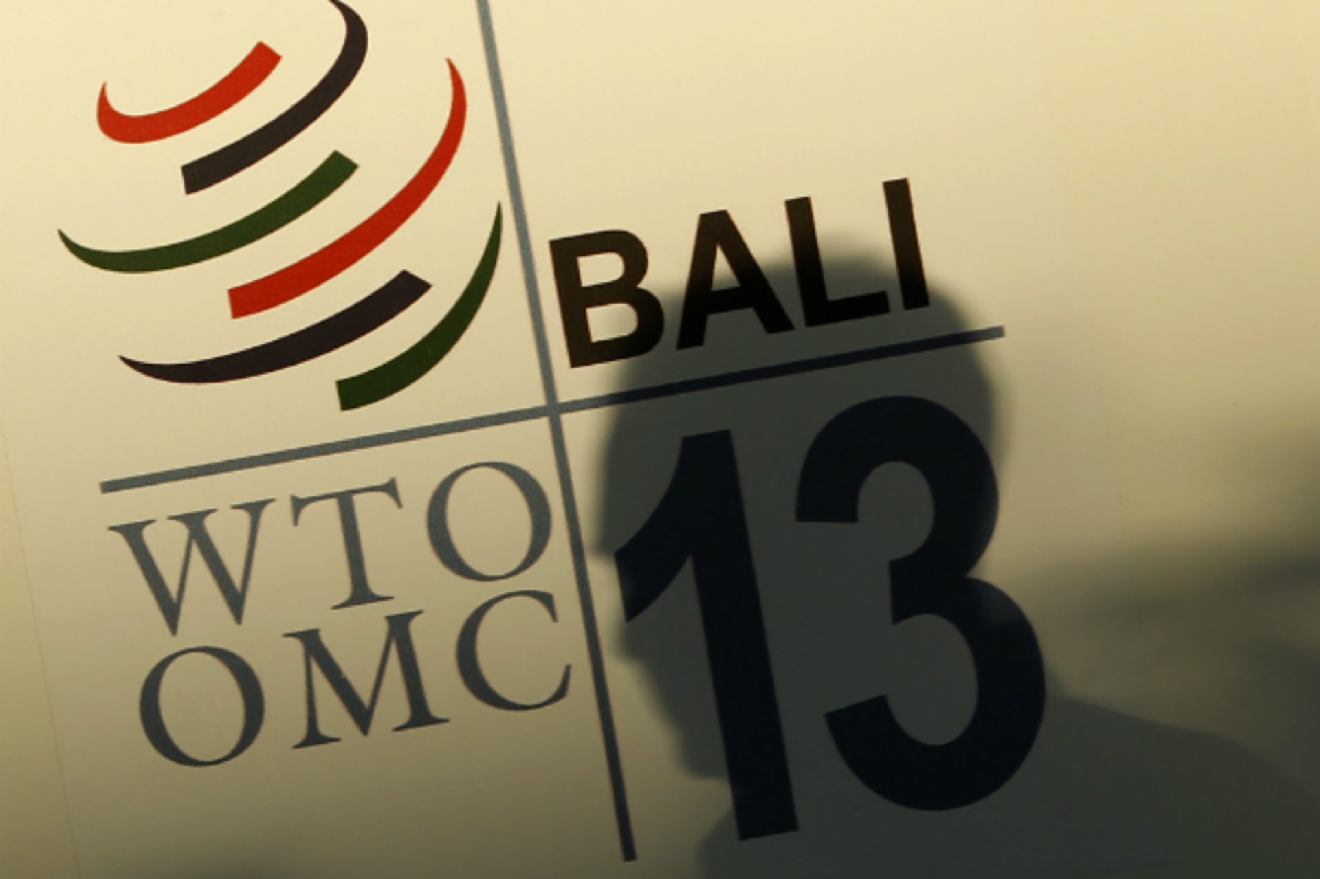<p>A man walks past a logo of the World Trade Organization (WTO) ahead of the ninth WTO Ministerial Conference in Nusa Dua, on the Indonesian resort island of Bali on December 2, 2013. (Edgar Su/Courtesy Reuters)</p>

