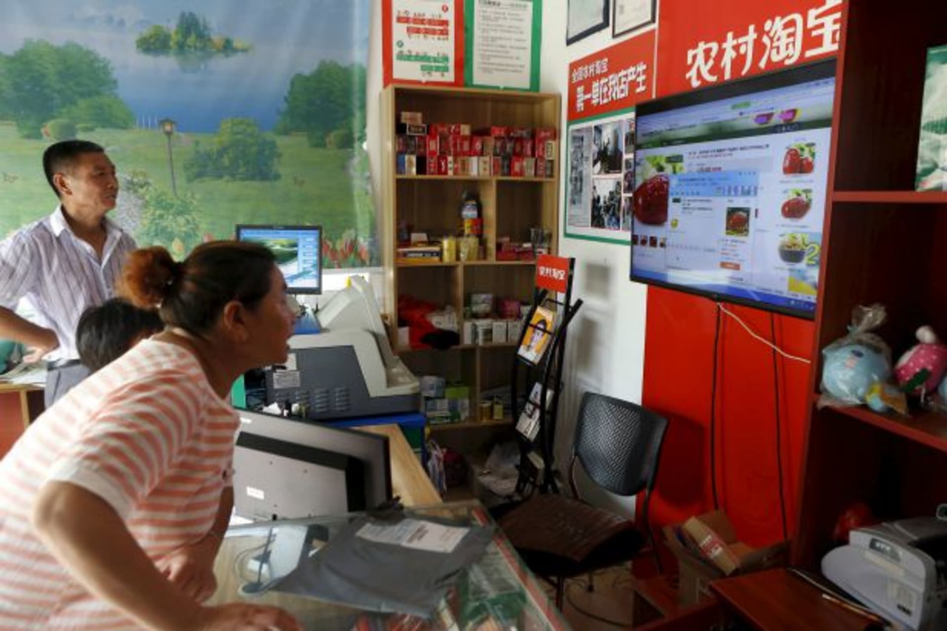<p>A customer shops at an Alibaba rural service center in Zhejiang province, China, July 20, 2015. While Chinese e-commerce compa…g at 460 billion yuan ($74 billion) by next year, new regulations on Internet payment tools may limit that. (Reuters/Aly Song)</p>
