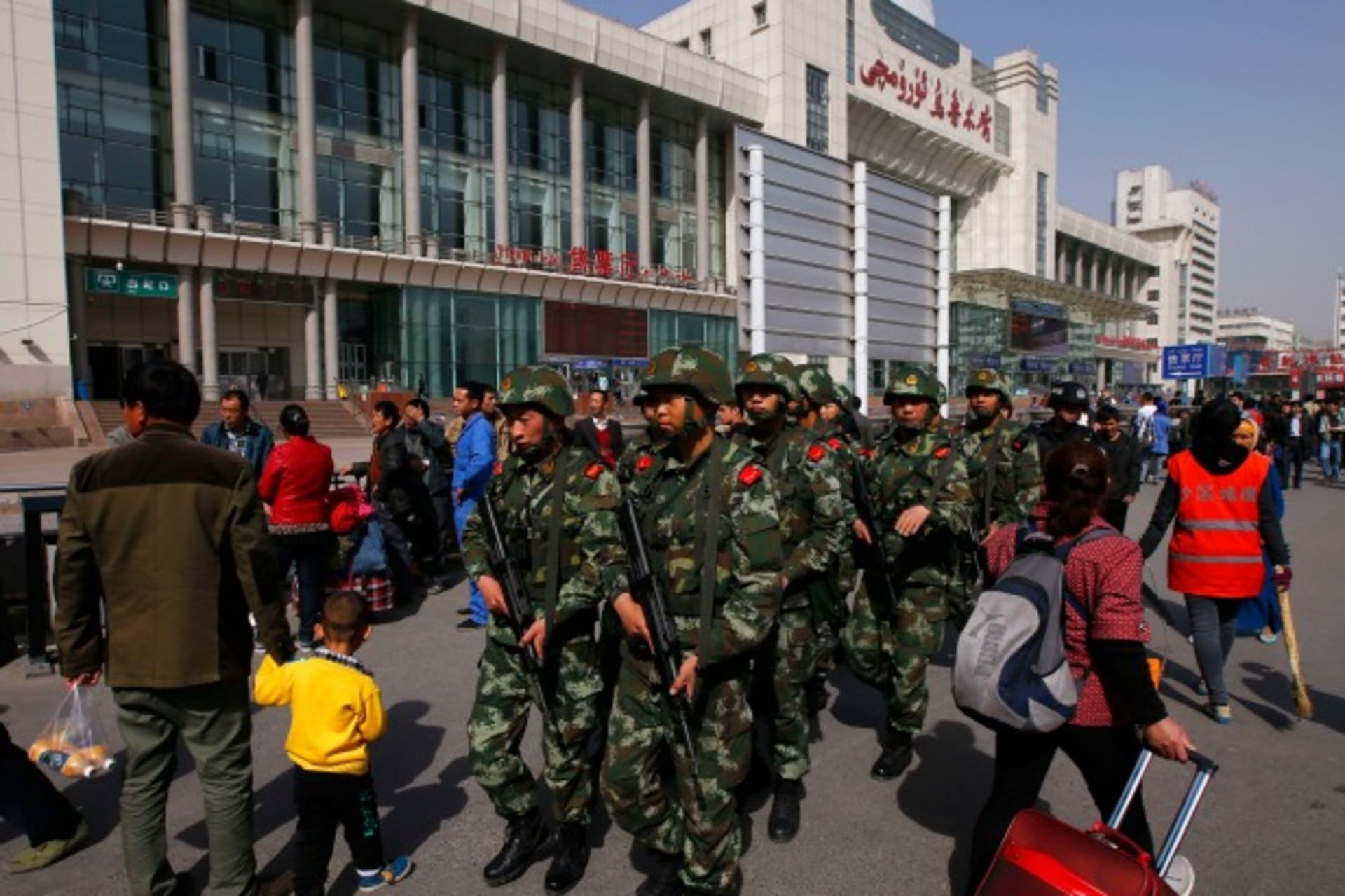 <p>Armed policemen patrol near the exit of the South Railway Station, where three people were killed and 79 wounded in Wednesday’s bomb and knife attack, in Urumqi, Xinjiang Uighur Autonomous region, on May 2, 2014. (Petar Kujundzic/Courtesy Reuters)</p>
