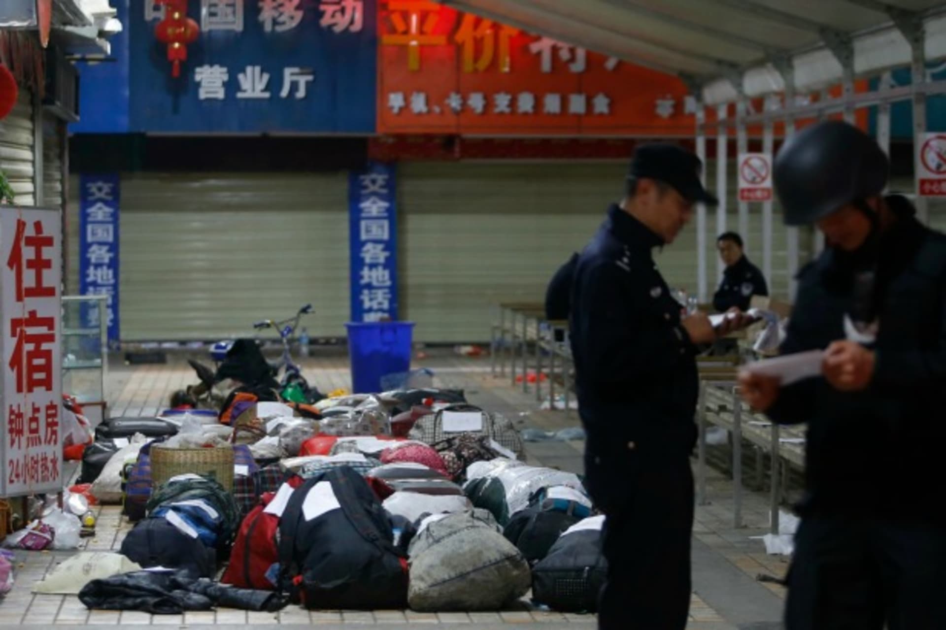 <p>Policemen check unclaimed luggage at a square outside the Kunming railway station after a knife attack, in Kunming, Yunnan province on March 2, 2014. (Stringer/Courtesy Reuters)</p>
