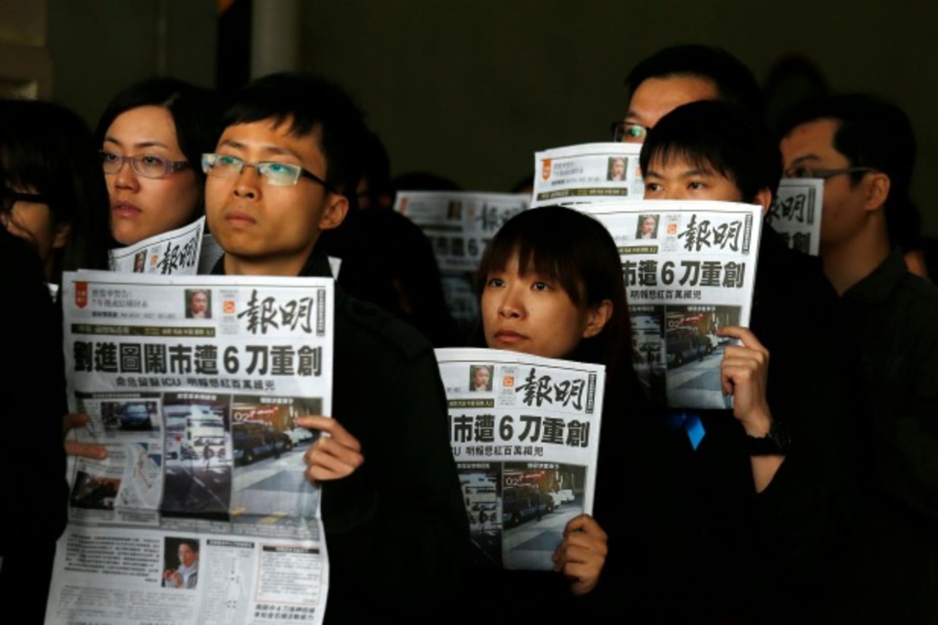 <p>Journalists and editors from Ming Pao hold up front pages of their newspaper during a protest against violence in Hong Kong February 27, 2014, after Wednesday’s attack on their former chief editor Kevin Lau. (Bobby Yip/Courtesy Reuters)</p>
