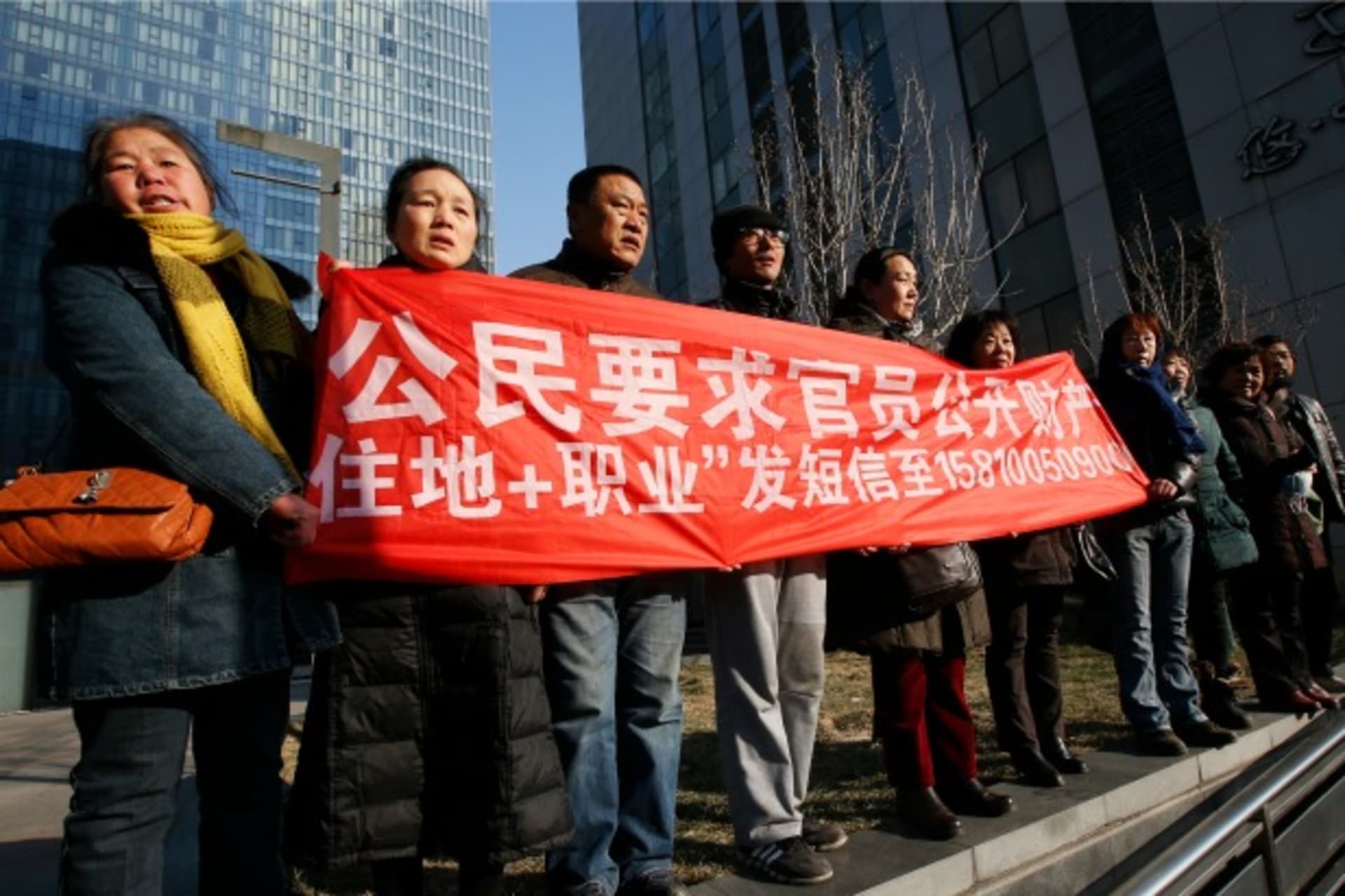<p>Supporters of Xu Zhiyong, one of China’s most prominent rights advocates, shout slogans near a court where Xu’s trial is being held, in Beijing on January 22, 2014. (Kim Kyung-hoon/Courtesy Reuters)</p>
