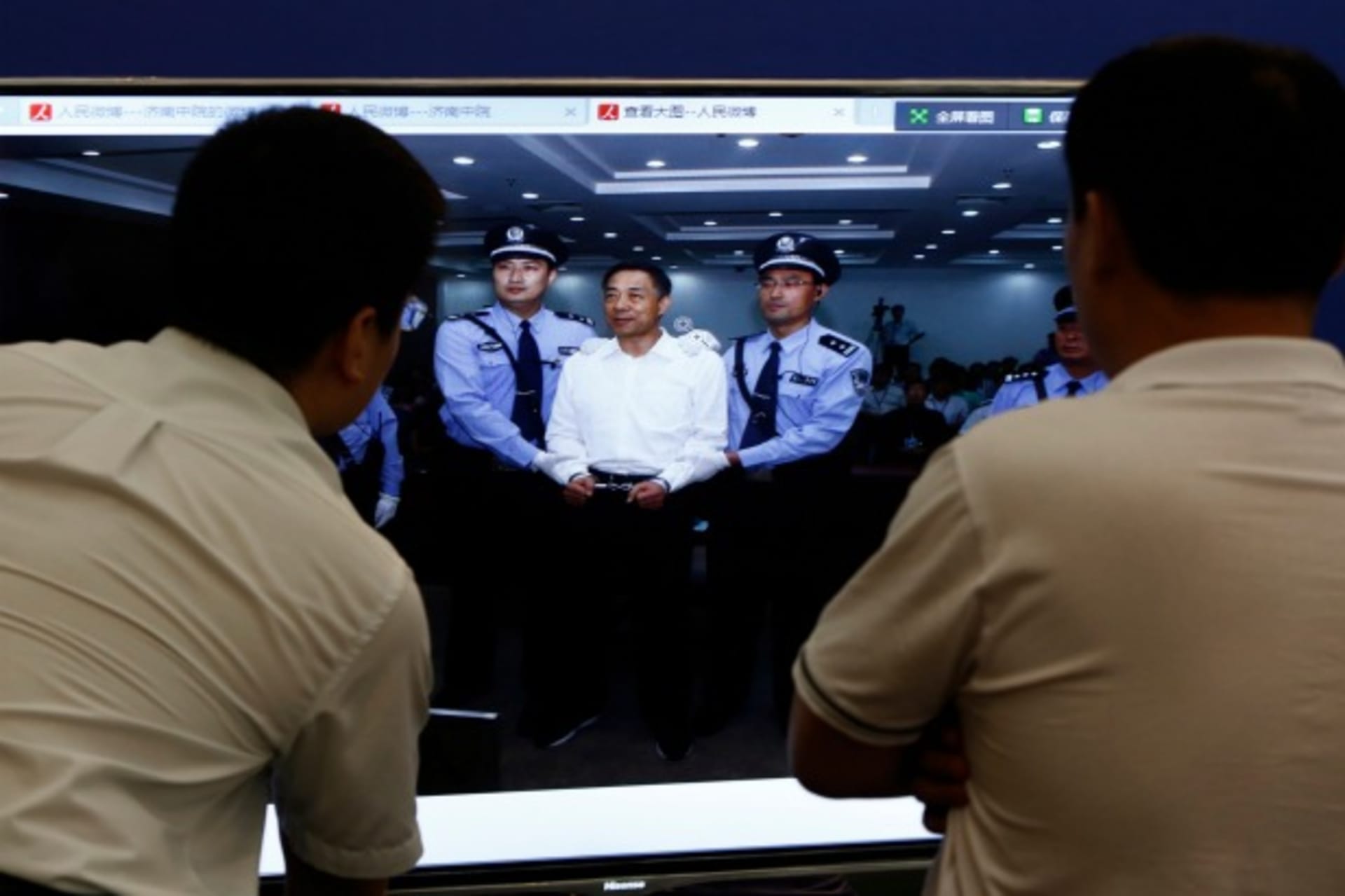 <p>Men look at a screen displaying a picture of disgraced Chinese politician Bo Xilai standing trial on the website of a court’s microblog, in Jinan, Shandong province on September 22, 2013 (Aly Song/Courtesy Reuters).</p>
