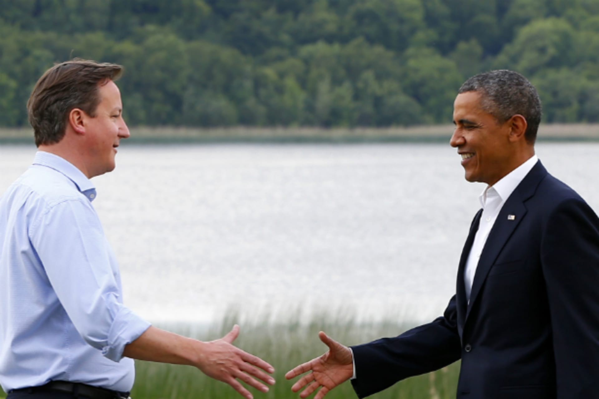 <p>Britain’s Prime Minister David Cameron welcomes U.S. President Barack Obama on his arrival to the Lough Erne golf resort where the G8 summit is taking place in Enniskillen, Northern Ireland on June 17, 2013. (Yves Herman/Courtesy Reuters)</p>
