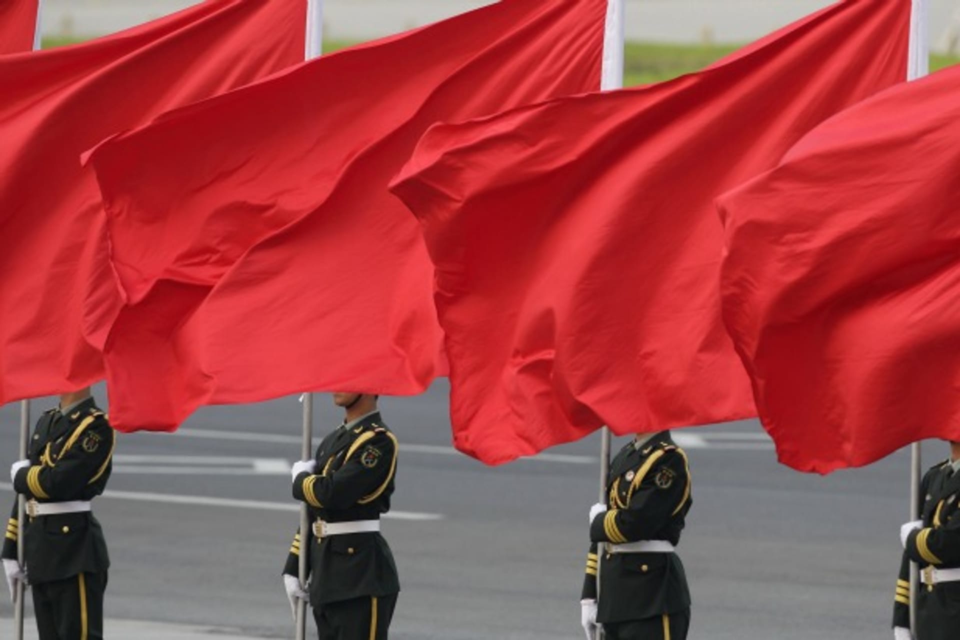 <p>Members of the People’s Liberation Army guard of honour stand with red flags during an official welcome ceremony outside the Great Hall of the People, in Beijing on April 15, 2013. (Courtesy Reuters/Jason Lee)</p>
