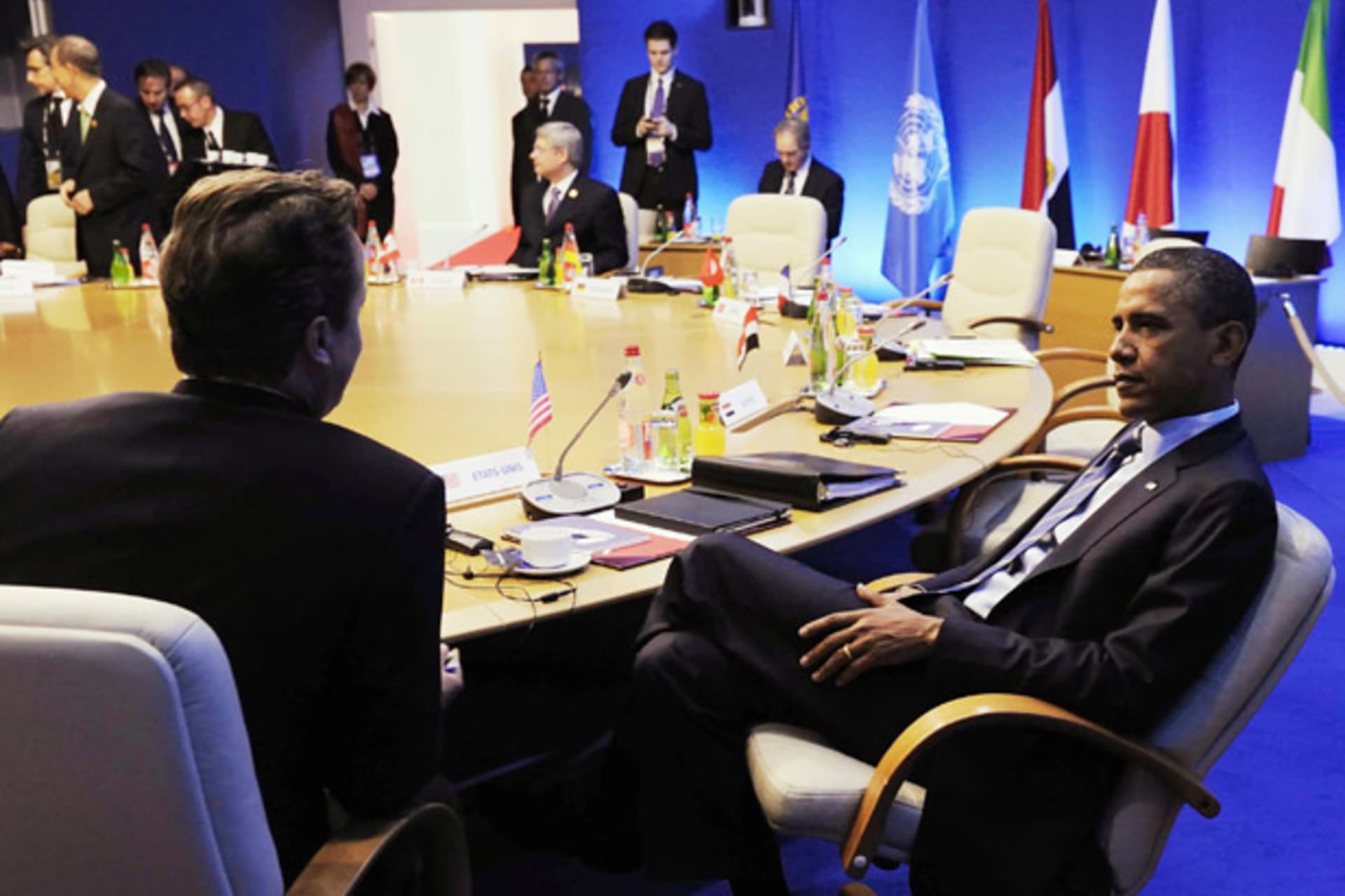 Britain's PM Cameron speaks with U.S. President Obama during a round table meeting at the G8 summit in Deauville