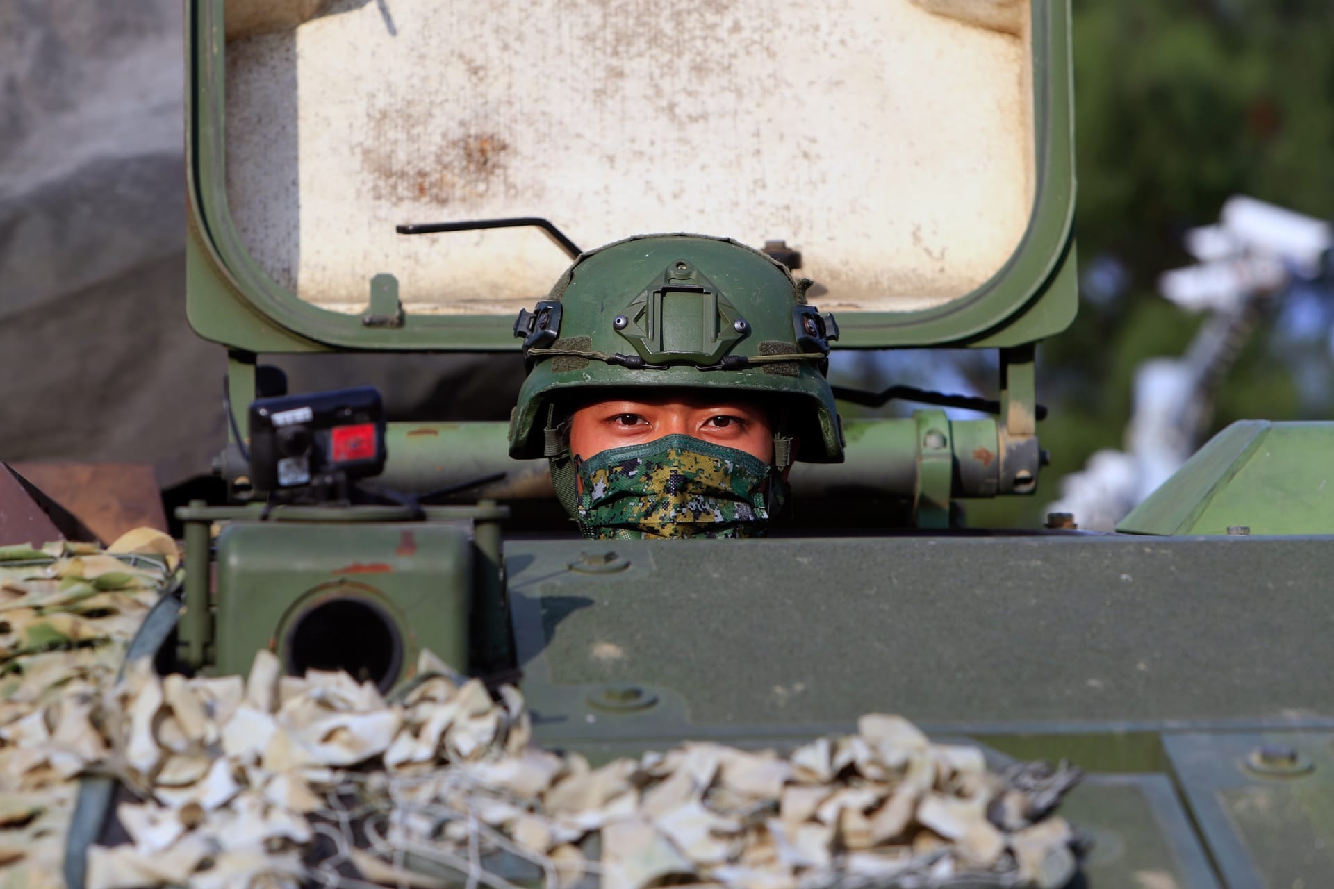 <p>A Taiwanese soldier peers out of a tank during the thirty-seventh annual Han Kuang military exercise in Tainan, Taiwan, on September 14, 2021.</p>
