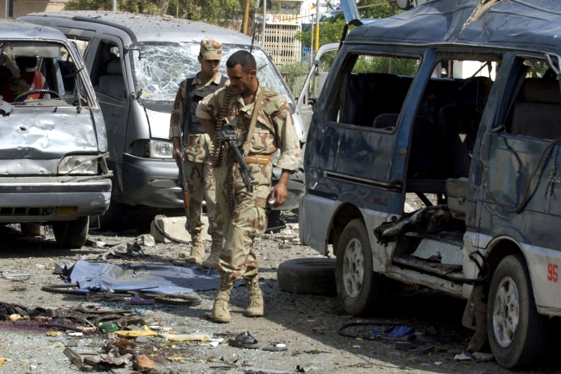 <p>Iraqi soldiers examine wreckages of cars that were destroyed in a car bomb explosion in Baghdad, Iraq, on April 29, 2005.</p>
