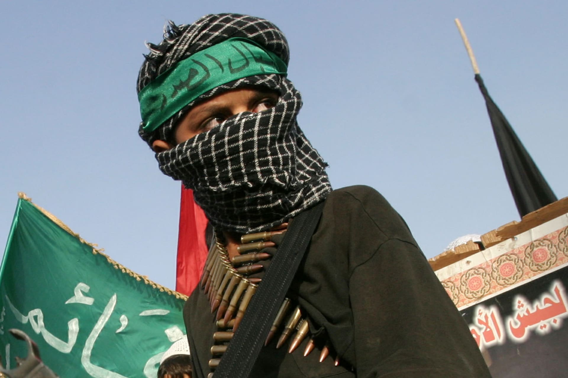 <p>Iraqi Shi’ite youths parade during a fourth day of mourning for slain Mehdi army militia commander Karim Daram in the Baghdad suburb of al Sadr city on June 16, 2004.</p>
