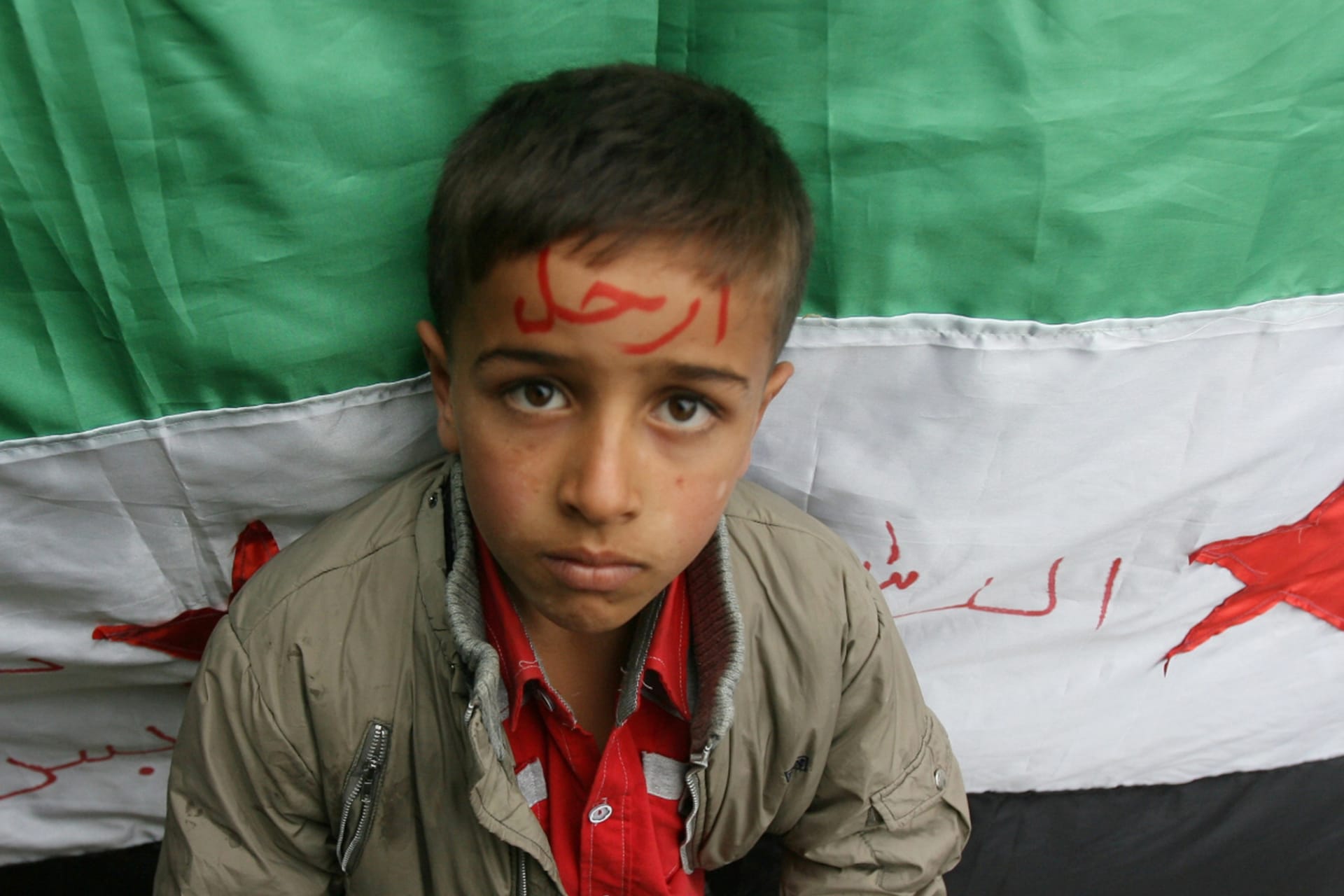 <p>A Syrian refugee child sits at an abandoned school in the Wady Khaled area, northern Lebanon, in November 12, 2011.</p>
