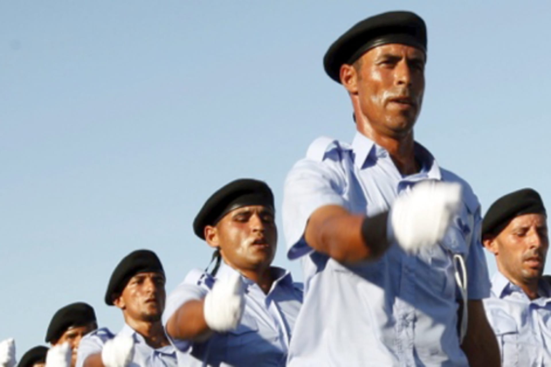 <p>Newly-graduated Libyan police officers march during their graduation ceremony in Tripoli, Libya, on June 8, 2015.</p>
