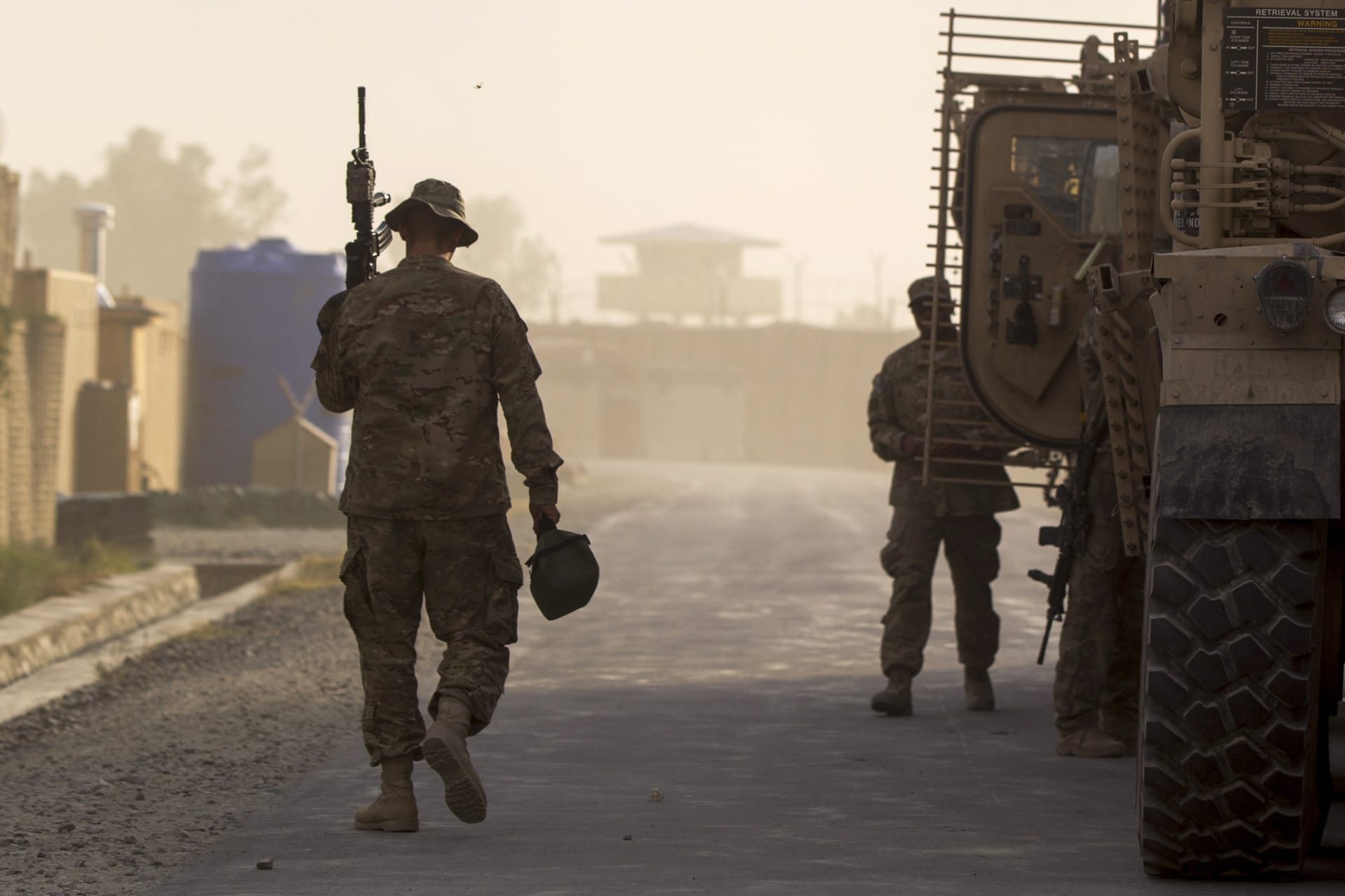 <p>A soldier from the 4th Brigade Combat Team, 4th Infantry Division walks with his weapon to an MRAP while preparing to leave in a convoy inside FOB Joyce in Afghanistan’s Kunar Province on June 24, 2012.</p>
