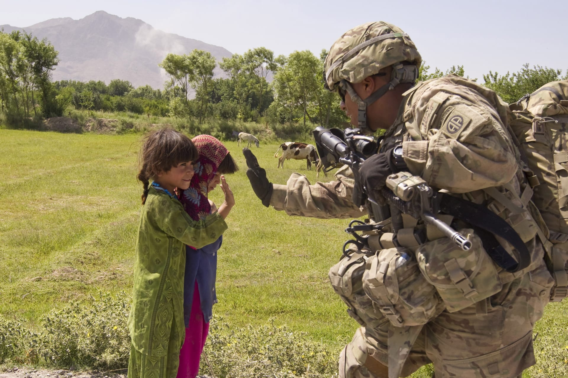 <p>A US soldier greets children during a patrol in Kandahar province. Two adults and their six children killed in incident in Paktia province, according to local officials.</p>
