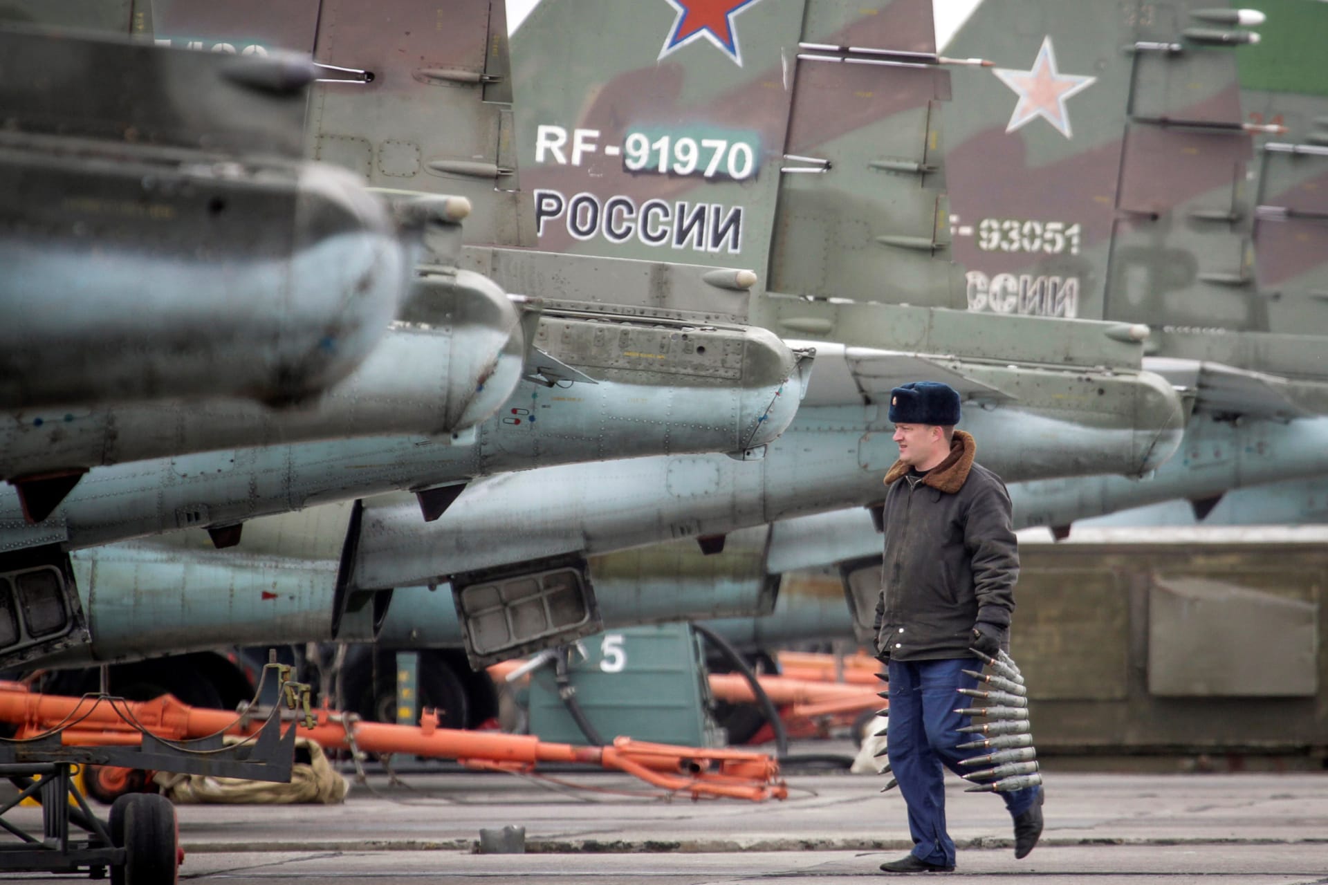 <p>A serviceman carries ammunition next to Sukhoi Su-25 jet fighters during a drill at the Russian southern Stavropol region on March 12, 2015.</p>

