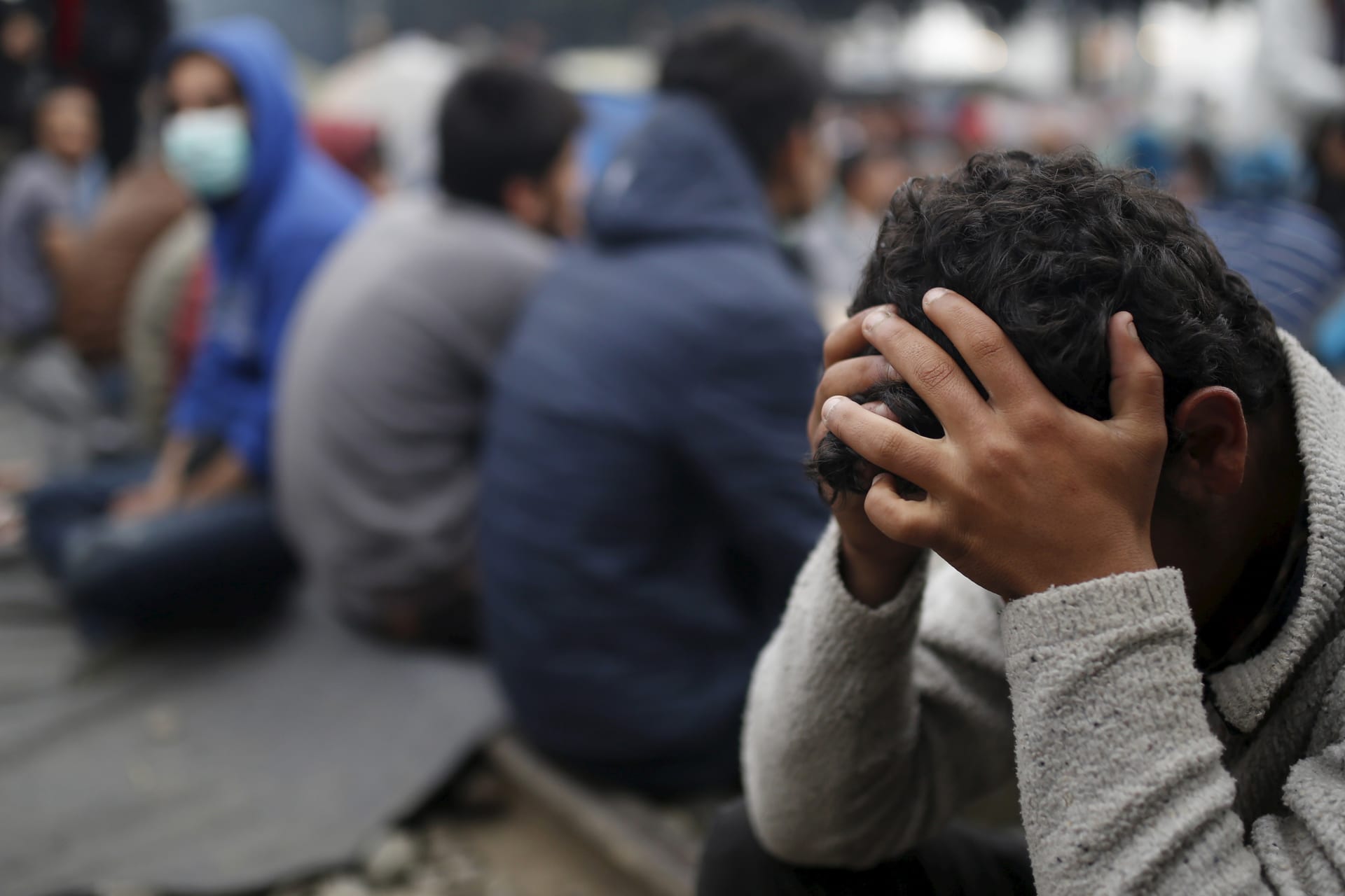 <p>Migrants and refugees sit on a railway track at a makeshift camp at the Greek-Macedonian border near the village of Idomeni, Greece, on April 3, 2016.</p>
