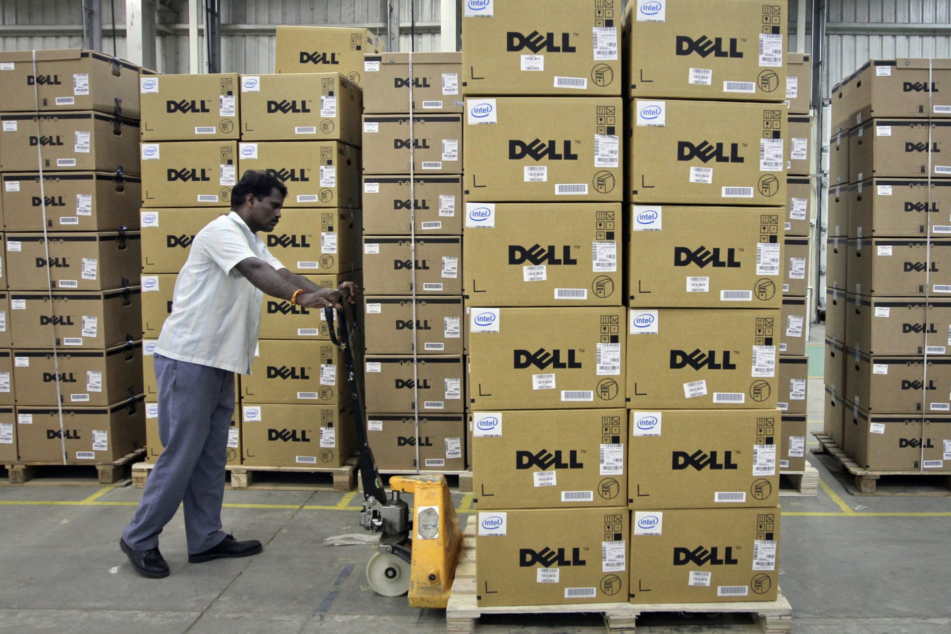<p>A man pushes a trolley full of Dell computers through a company factory in Sriperumbudur Taluk, in the Kancheepuram district of the southern Indian state of Tamil Nadu, in June 2, 2011.</p>
