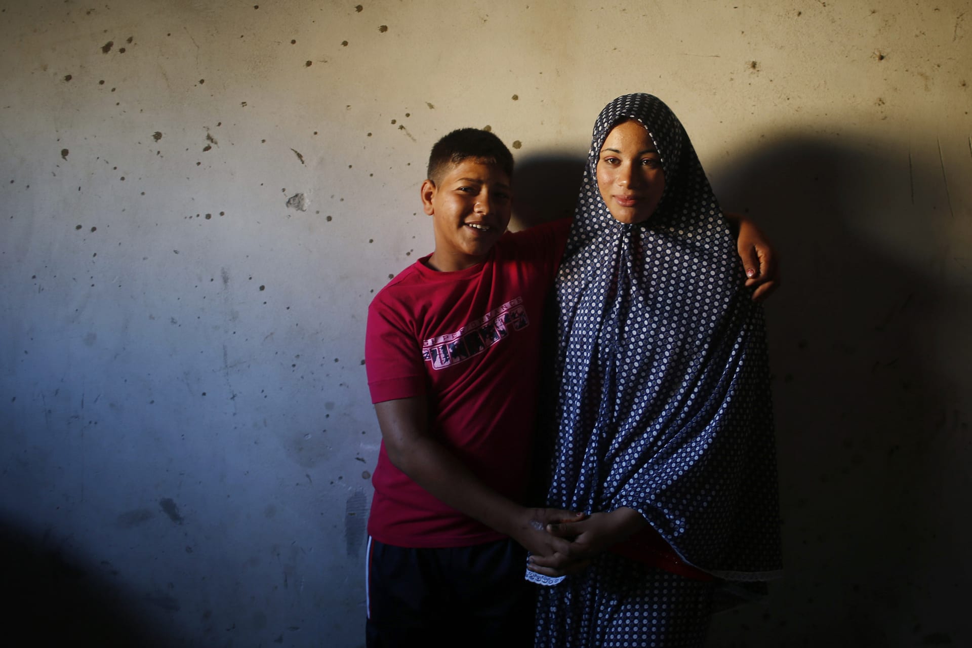 <p>Newly married Tala Soboh, 14, poses for a photograph with her 15-year-old husband Ahmed two days after their marriage in the town of Beit Lahiya, near the border between Israel and the northern Gaza Strip on September 26, 2013.</p>