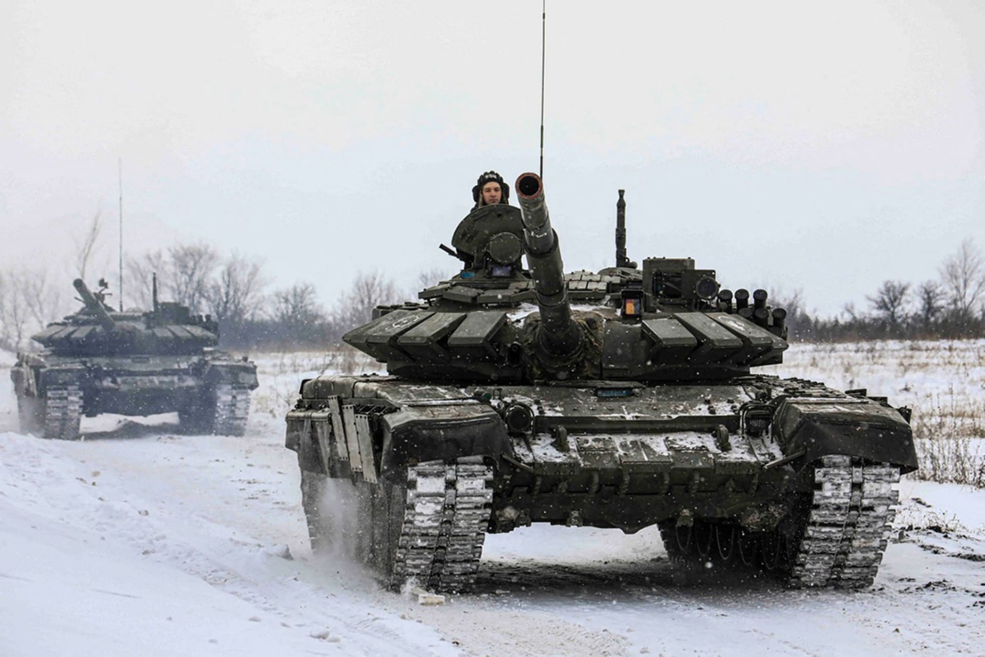 <p>Russian servicemen drive tanks during military exercises in the Leningrad Region, Russia, released on February 14, 2022.</p>
