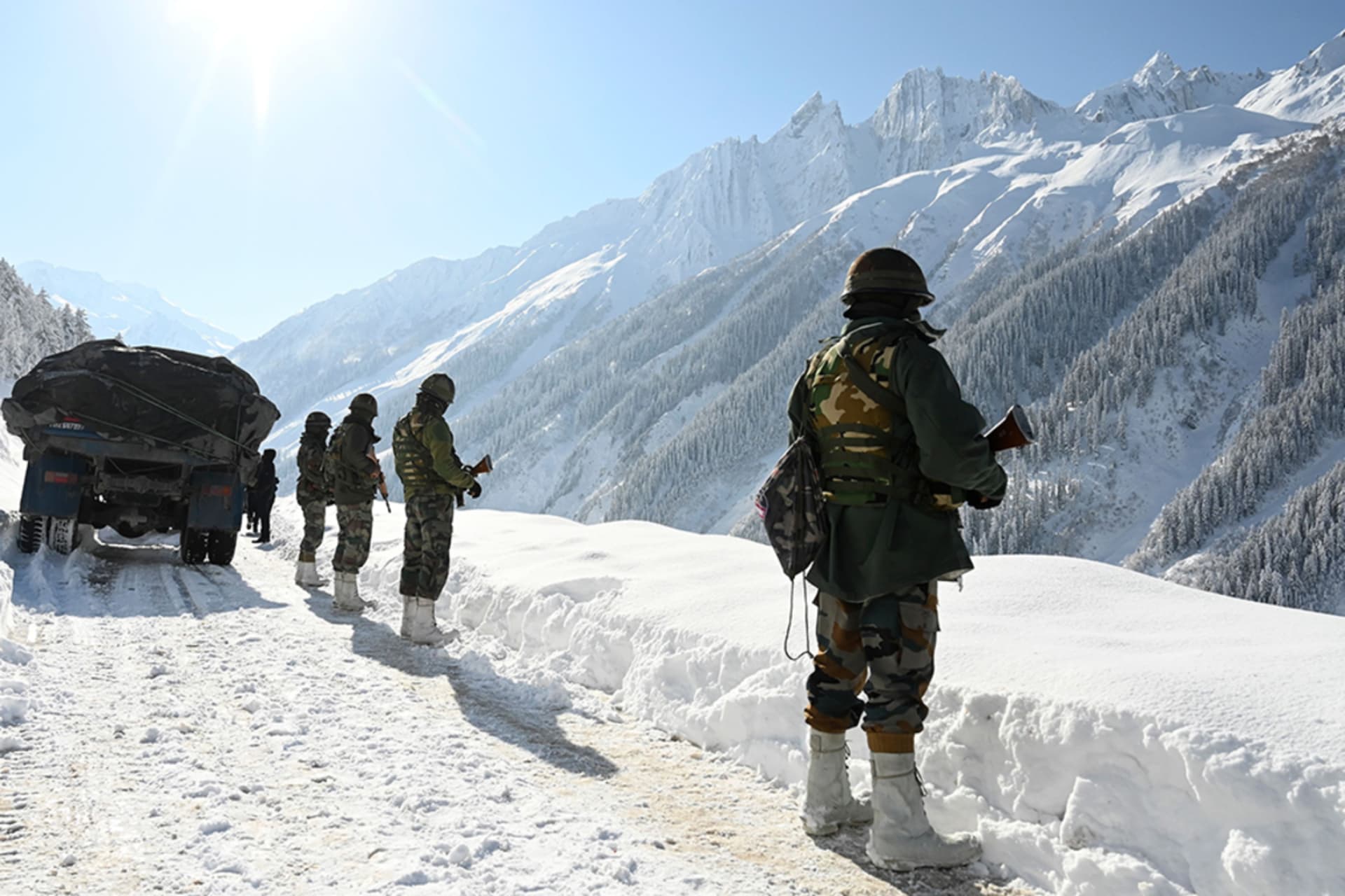 <p>Indian soldiers walk along a road near Zojila mountain pass, bordering China, on February 28, 2021. </p>

