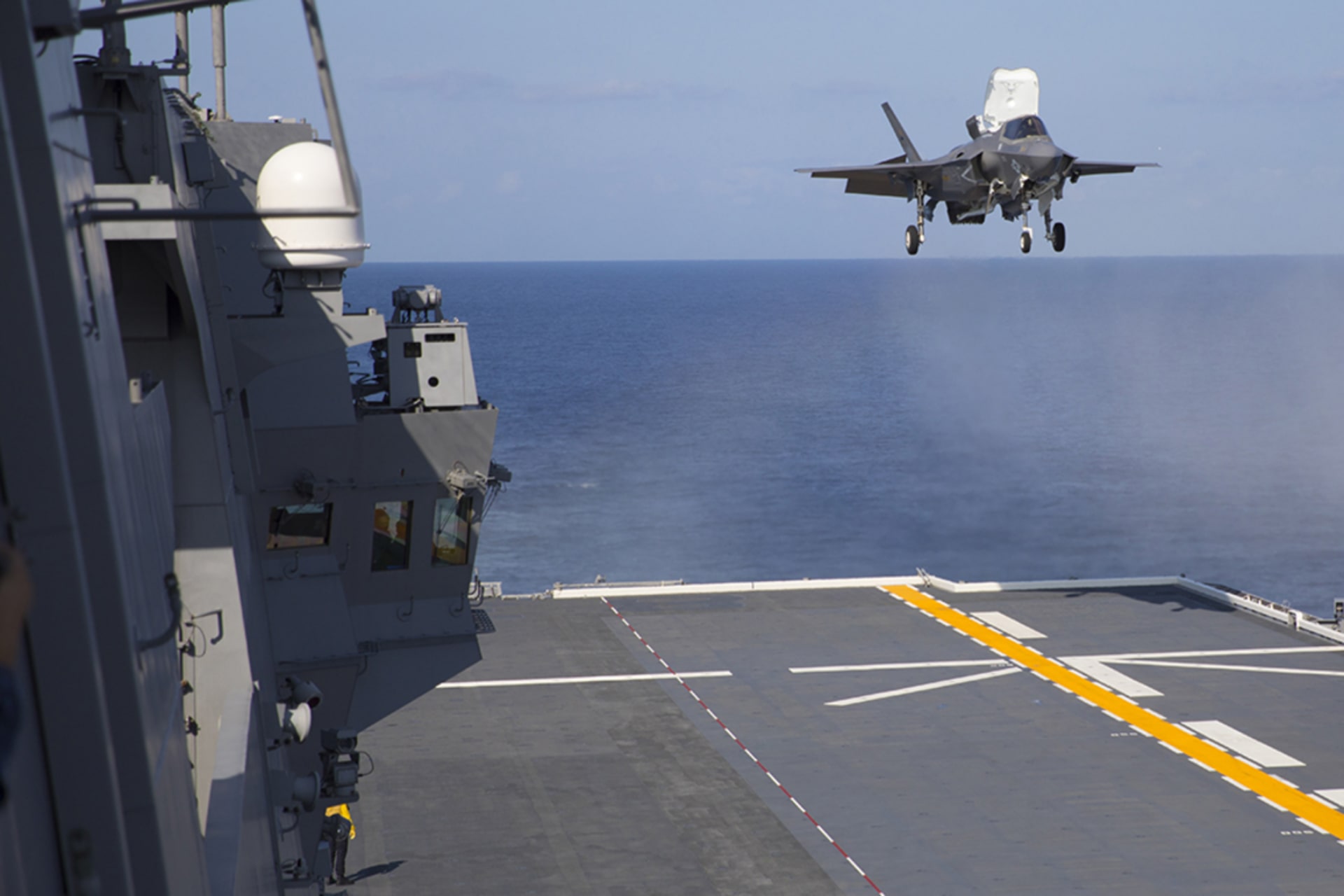 <p>A U.S. Marine Corps F-35B Lightning II aircraft conducts a vertical landing aboard the Japanese Ship Izumo off the coast of Japan in October 2021.</p>
