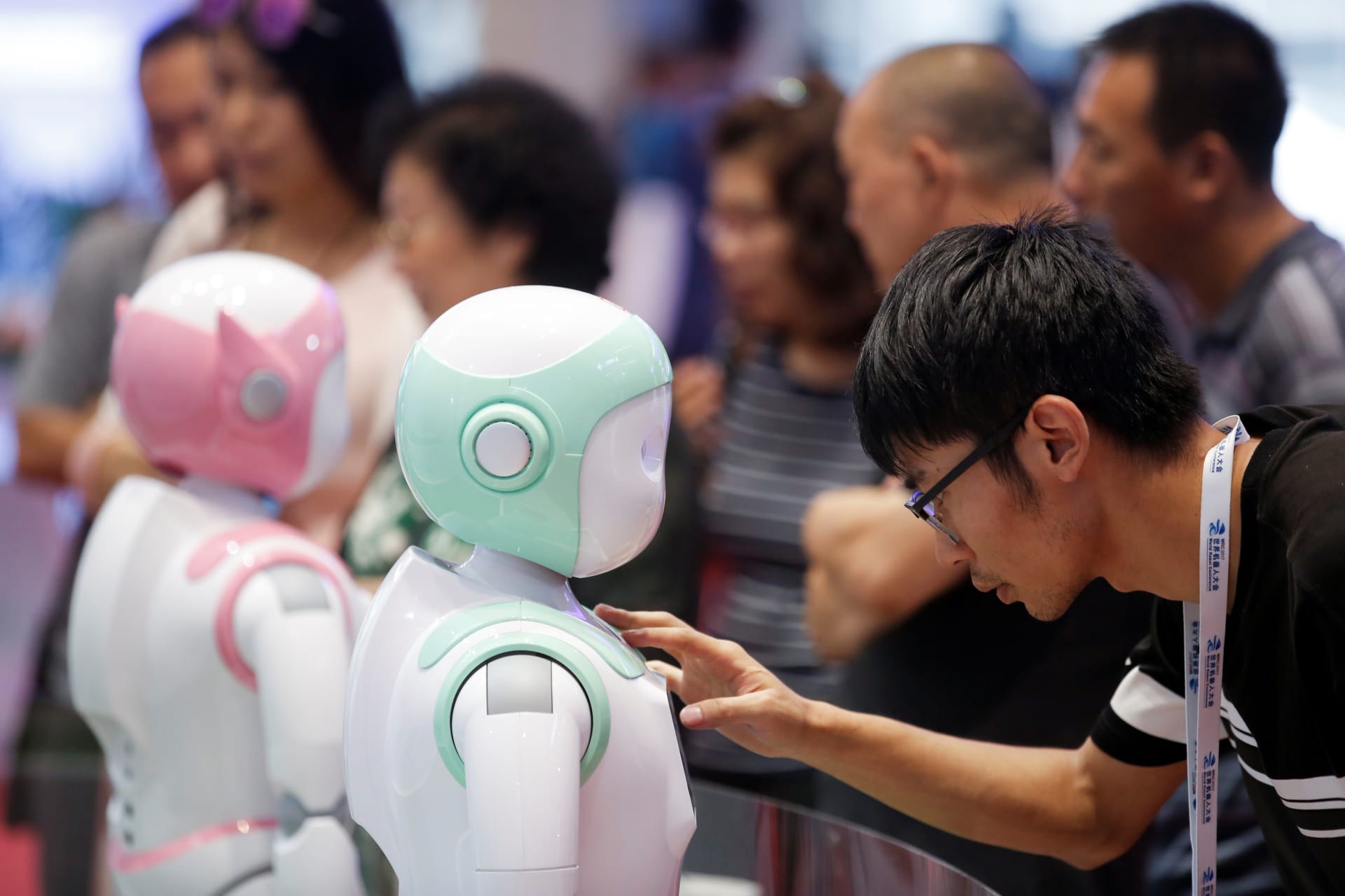 <p>A man programs an iPal Companion Robot by Nanjing Avatar Mind Robot Technology at the 2017 World Robot conference in Beijing, on August 22, 2017.</p>
