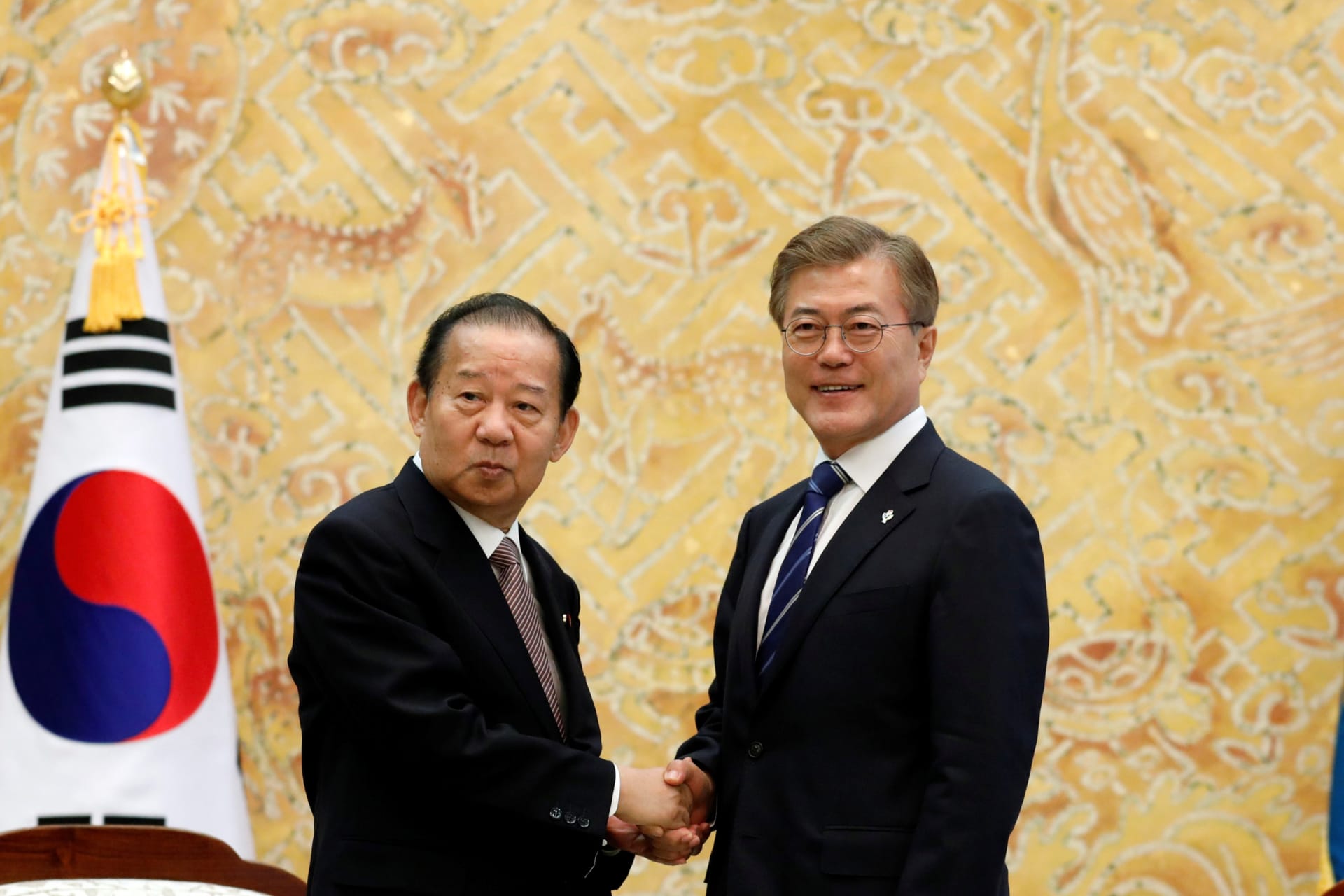 <p>South Korean President Moon Jae-in (R) shakes hands with Toshihiro Nikai, Secretary General of the Japanese Liberal Democratic Party, during their meeting at the Presidential Blue House in Seoul, South Korea, on June 12, 2017.</p>
