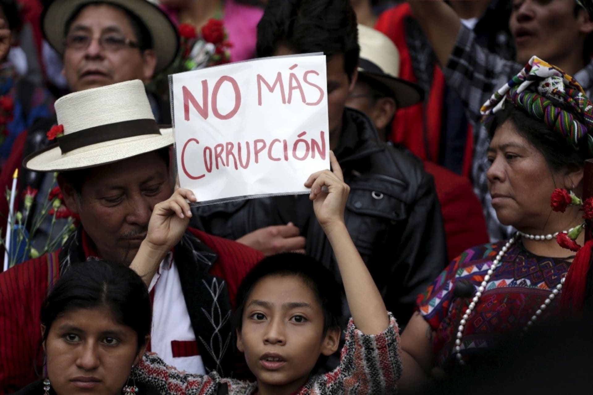 <p>A boy holds a sign that reads “No more corruption” during a demonstration demanding the resignation of Guatemalan President Otto Perez Molina, in downtown Guatemala City, May 30, 2015.</p>
